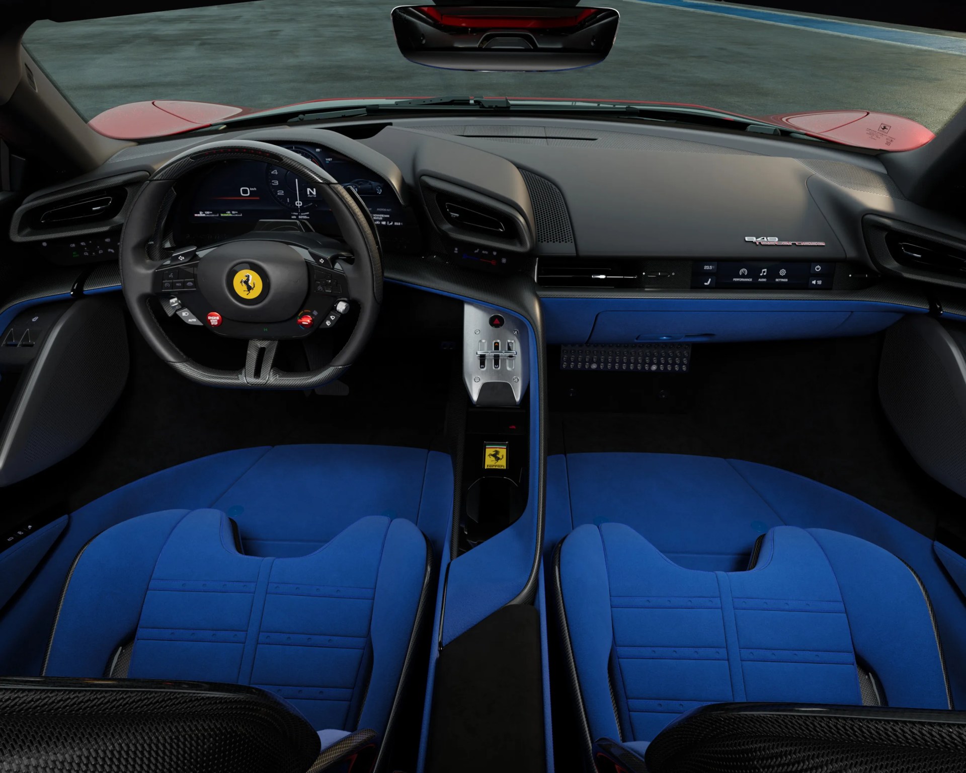 Interior of a Ferrari 348 with a black dashboard and steering wheel featuring the Ferrari logo, complemented by vibrant blue racing-style seats and blue accents on the center console and door panels. The dashboard includes a digital display behind the steering wheel and a touchscreen panel on the passenger side. The center console has metallic controls and a Ferrari emblem.