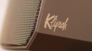 Close-up of a brown Klipsch speaker showing the brand logo and part of the speaker grille.