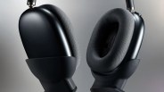 Close-up of black over-ear headphones with cushioned, textured ear pads and a smooth matte finish on the outer ear cups.