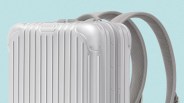 Silver hard-shell backpack with vertical ridges and padded shoulder straps.