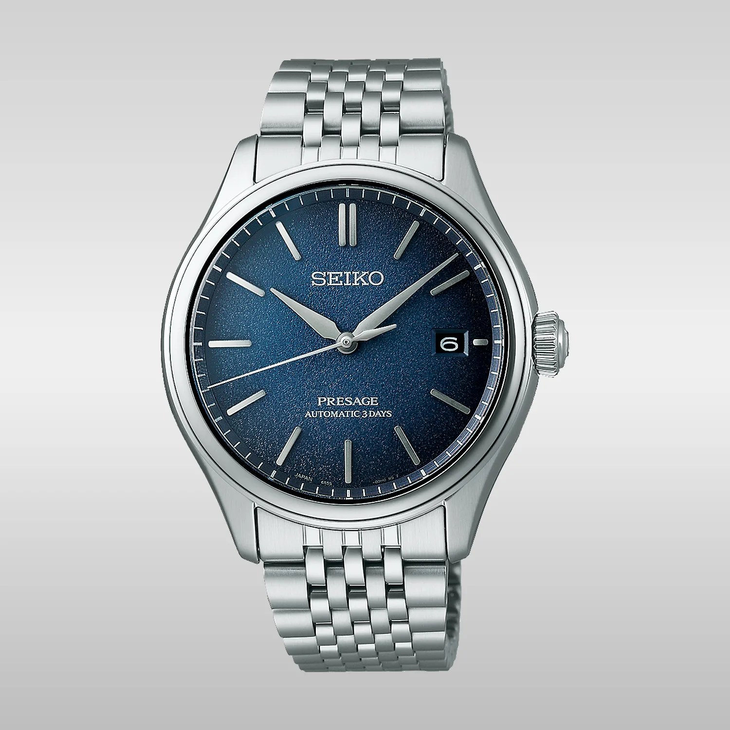 Seiko Presage automatic wristwatch with a textured dark blue dial, silver hour markers, and hands. The watch features a date window at 3 o'clock and a stainless steel case and bracelet. The dial includes the text "SEIKO," "PRESAGE," and "AUTOMATIC 3 DAYS.