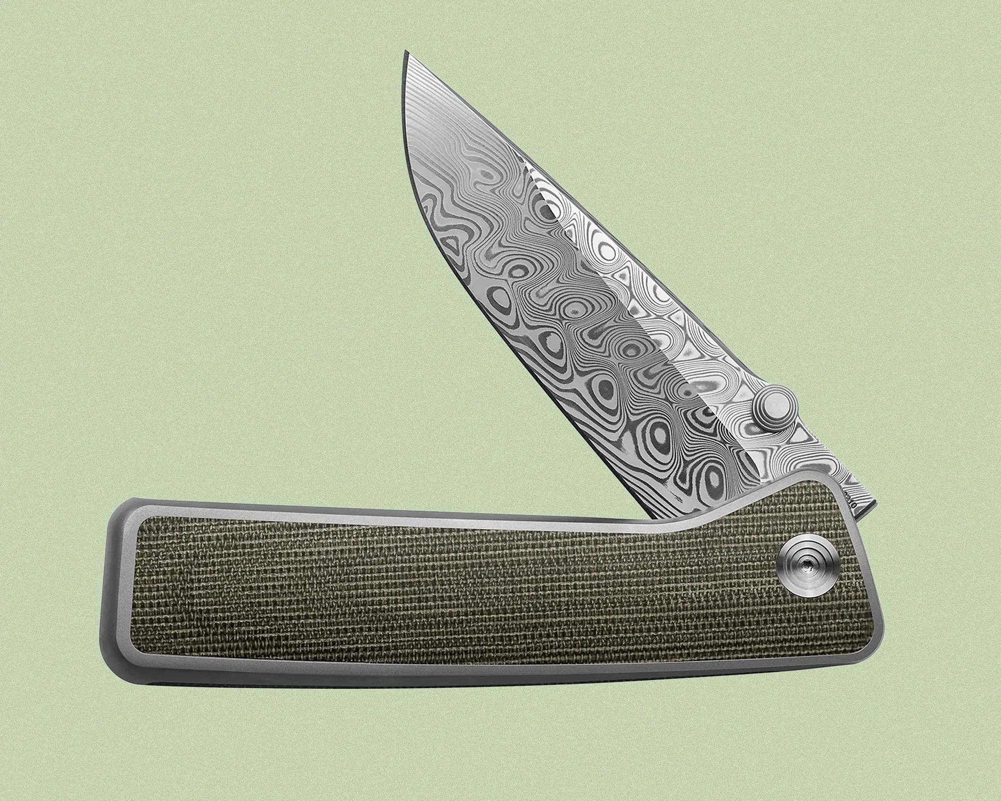 Folding knife with a partially open blade featuring a distinctive Damascus steel pattern. The handle has a textured, dark green material inset within a smooth, metallic frame. The knife is set against a light green background.