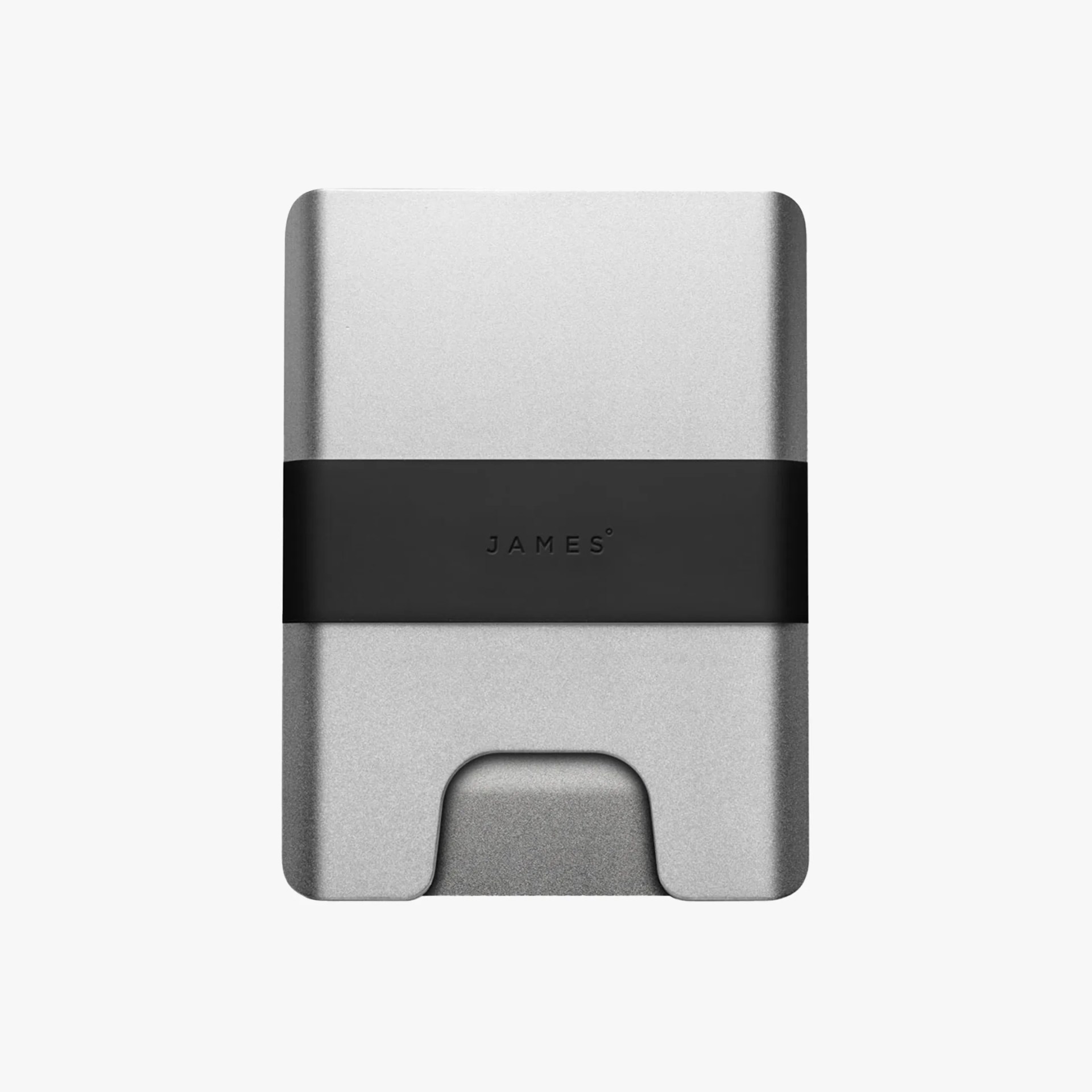 A minimalist, rectangular wallet made of silver metal with rounded edges. It features a black elastic band around the middle with the brand name "JAMES" embossed on it. The wallet has a small cutout at the bottom center for easy access to cards.