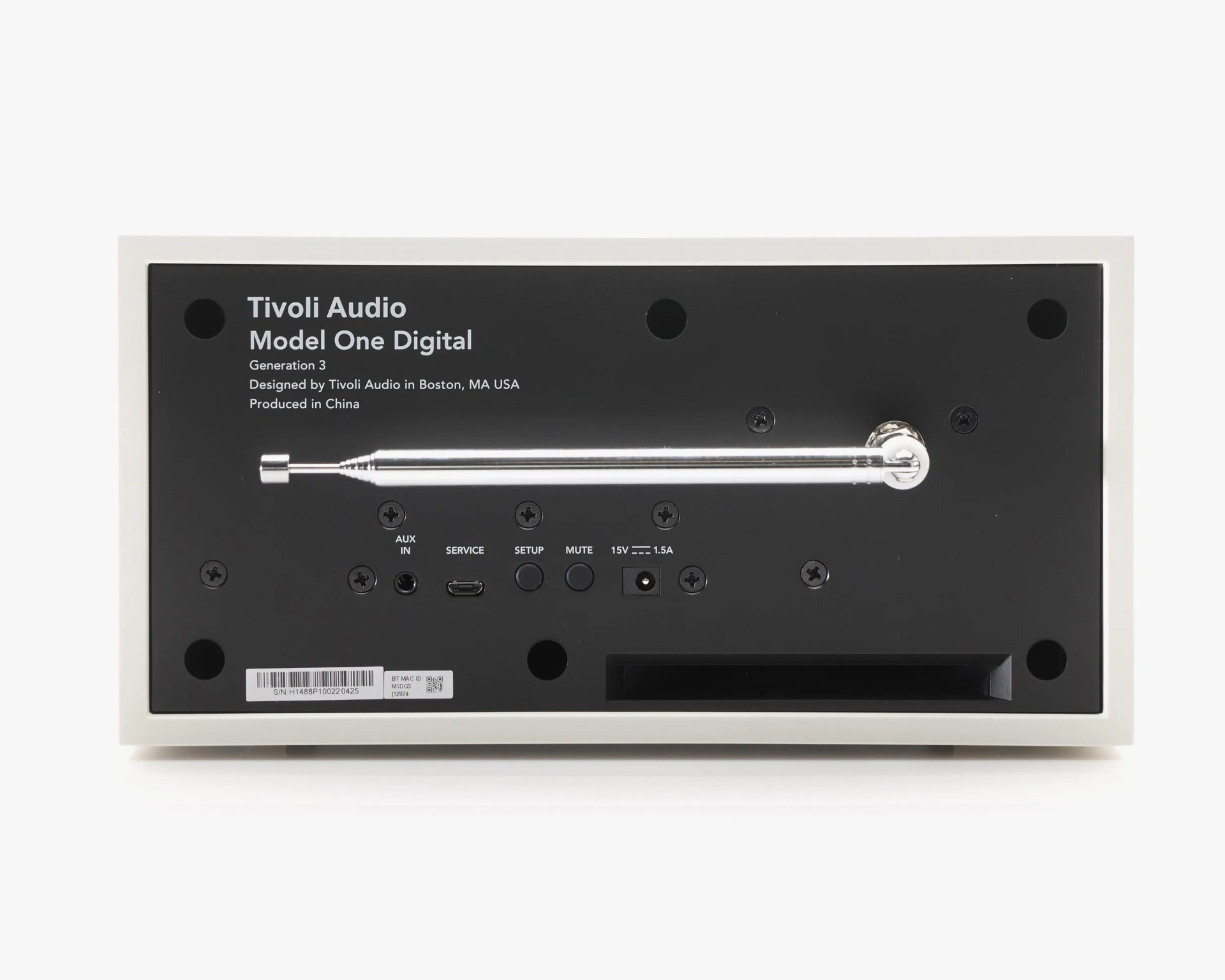 Back panel of a Tivoli Audio Model One Digital Generation 3 radio, featuring a retractable metal antenna, AUX IN port, SERVICE USB port, SETUP and MUTE buttons, a 15V 1.5A power input, and a barcode label. The panel is black with white text and is framed by a white casing.