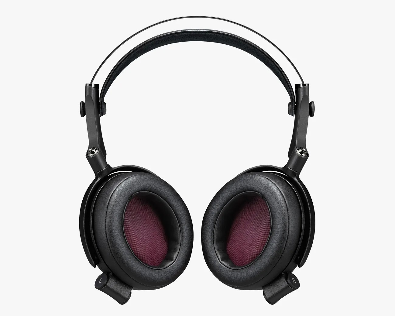 Black over-ear headphones with padded ear cups featuring a dark red inner mesh, a double headband design with a thin metal band above a thicker padded band, and adjustable hinges connecting the ear cups to the headband.