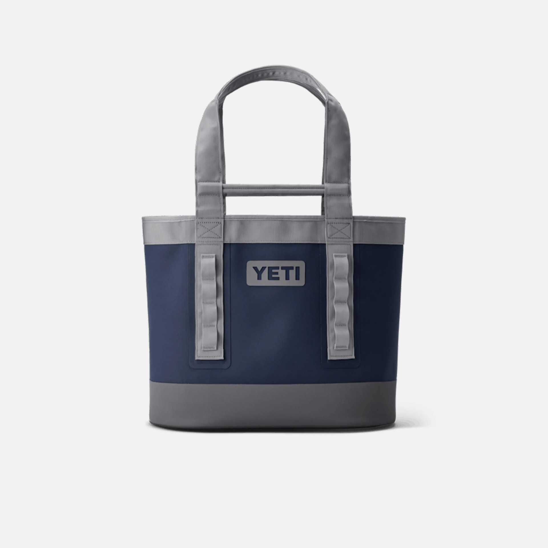 Navy blue and gray YETI tote bag with two sturdy handles and a reinforced bottom. The bag features the YETI logo on the front center.
