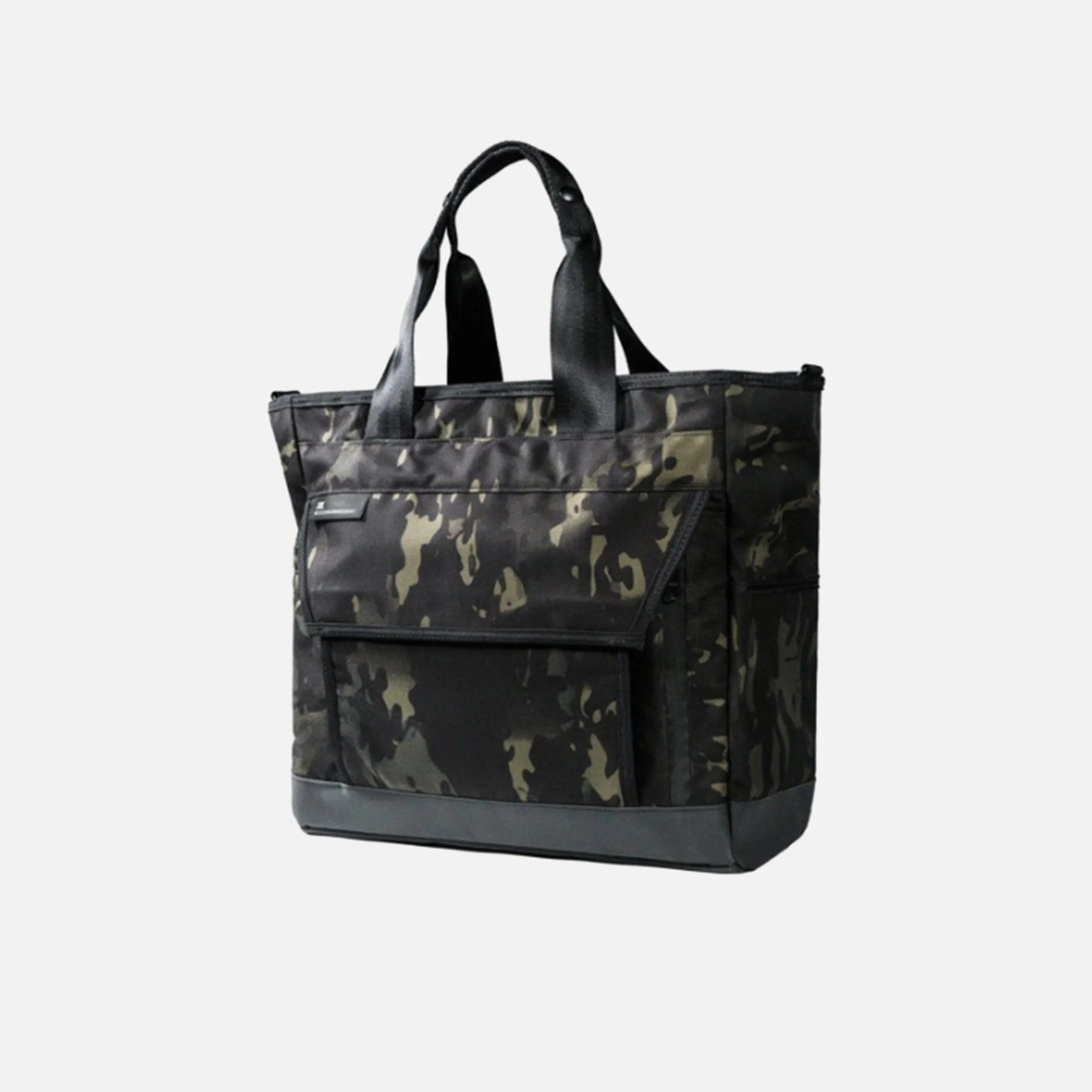 Black and dark green camouflage-patterned tote bag with two short handles. The bag features a large front pocket with a flap closure and a reinforced black base. The material appears to be durable fabric.
