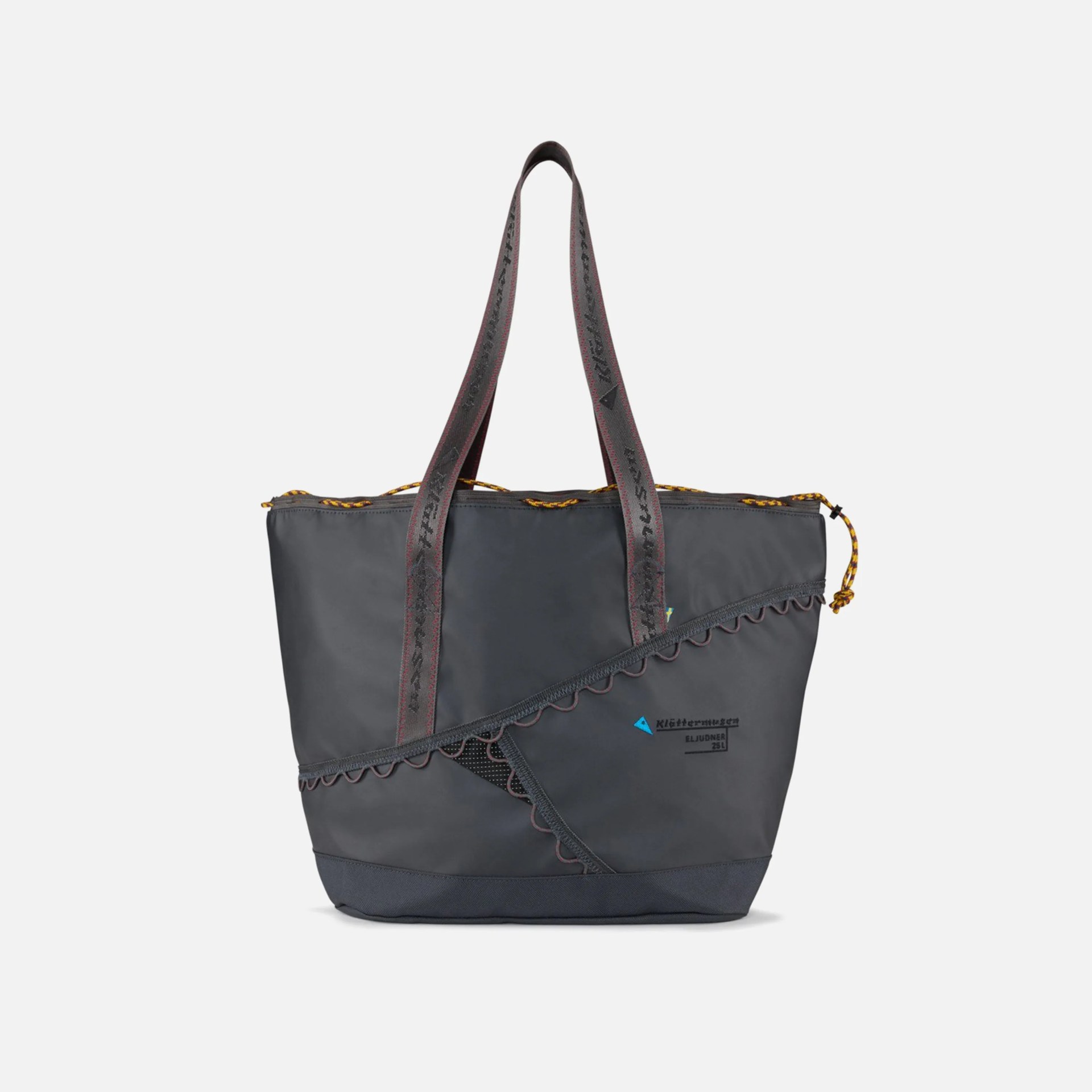 Dark gray tote bag with two long handles featuring black text. The bag has a diagonal mesh pocket with scalloped trim on the front and a yellow and black drawstring closure at the top. The brand name "Kl&auml;ttermusen" and model "ELJUDNER 25L" are printed on the front.