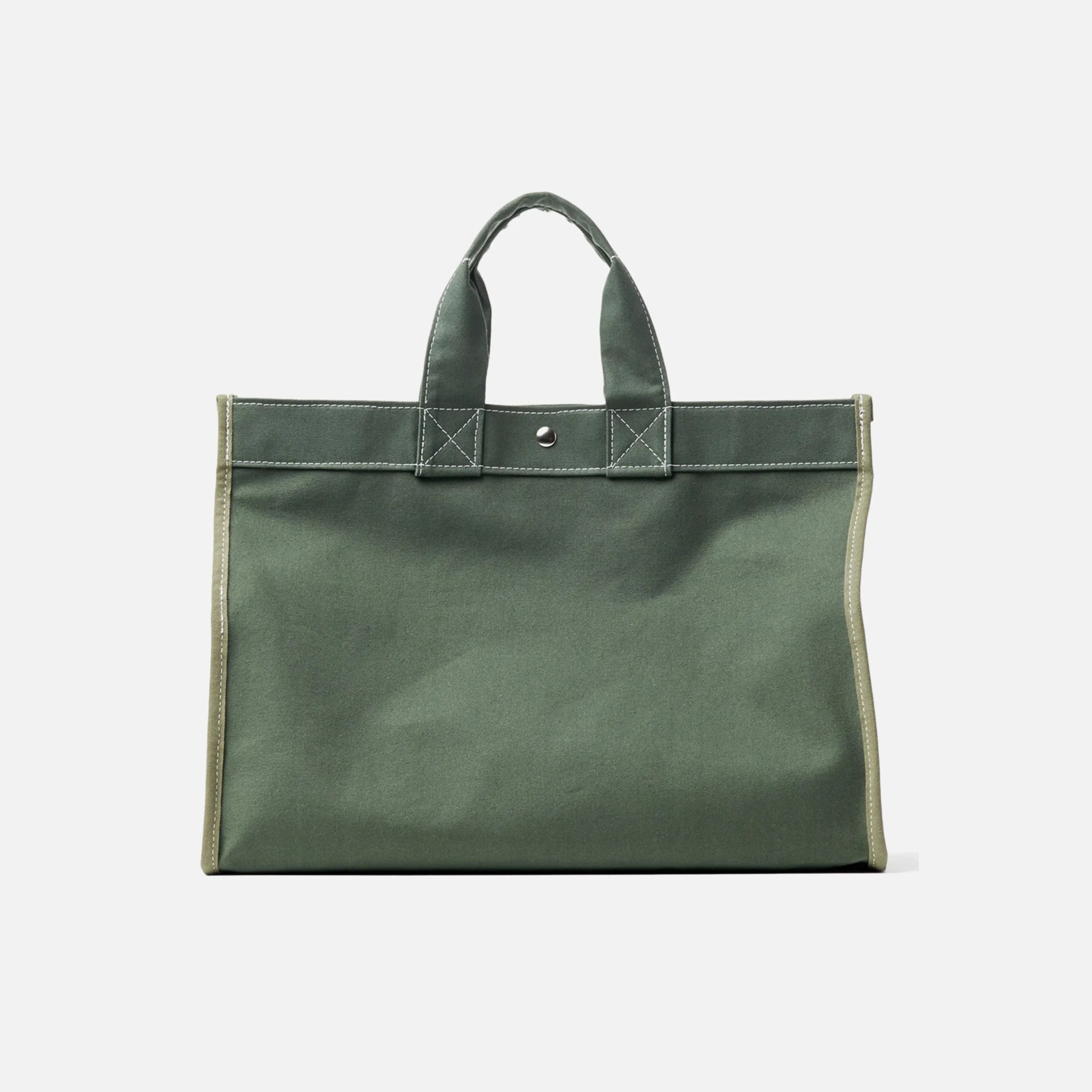 Green canvas tote bag with short handles, reinforced stitching, and a snap button closure at the top center. The edges are trimmed with a lighter green fabric.