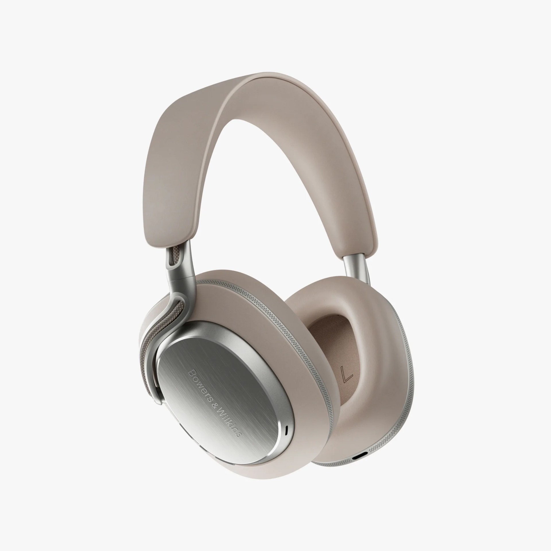 Over-ear headphones with a sleek, modern design featuring beige cushioned ear cups and headband. The outer ear cups have a brushed silver finish with the brand name "Bowers & Wilkins" subtly engraved. The headphones have a minimalist and premium look with smooth curves and metal accents.