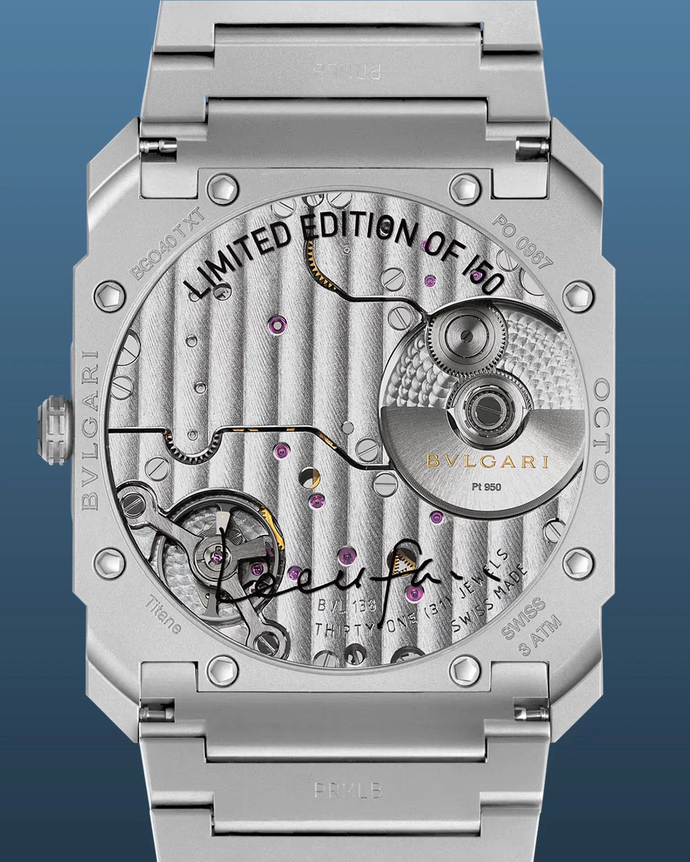 Back view of a Bulgari Octo wristwatch showcasing its intricate mechanical movement. The watch features a titanium case with visible screws and a transparent case back revealing the inner workings, including gears and jewels. The text "LIMITED EDITION OF 150," "BVLGARI," "Pt 950," "THIRTY-ONE (31) JEWELS," "SWISS MADE," "SWISS 3 ATM," and "Titan" are engraved on the case and movement. The watch has a metal bracelet and a signature on the movement plate.