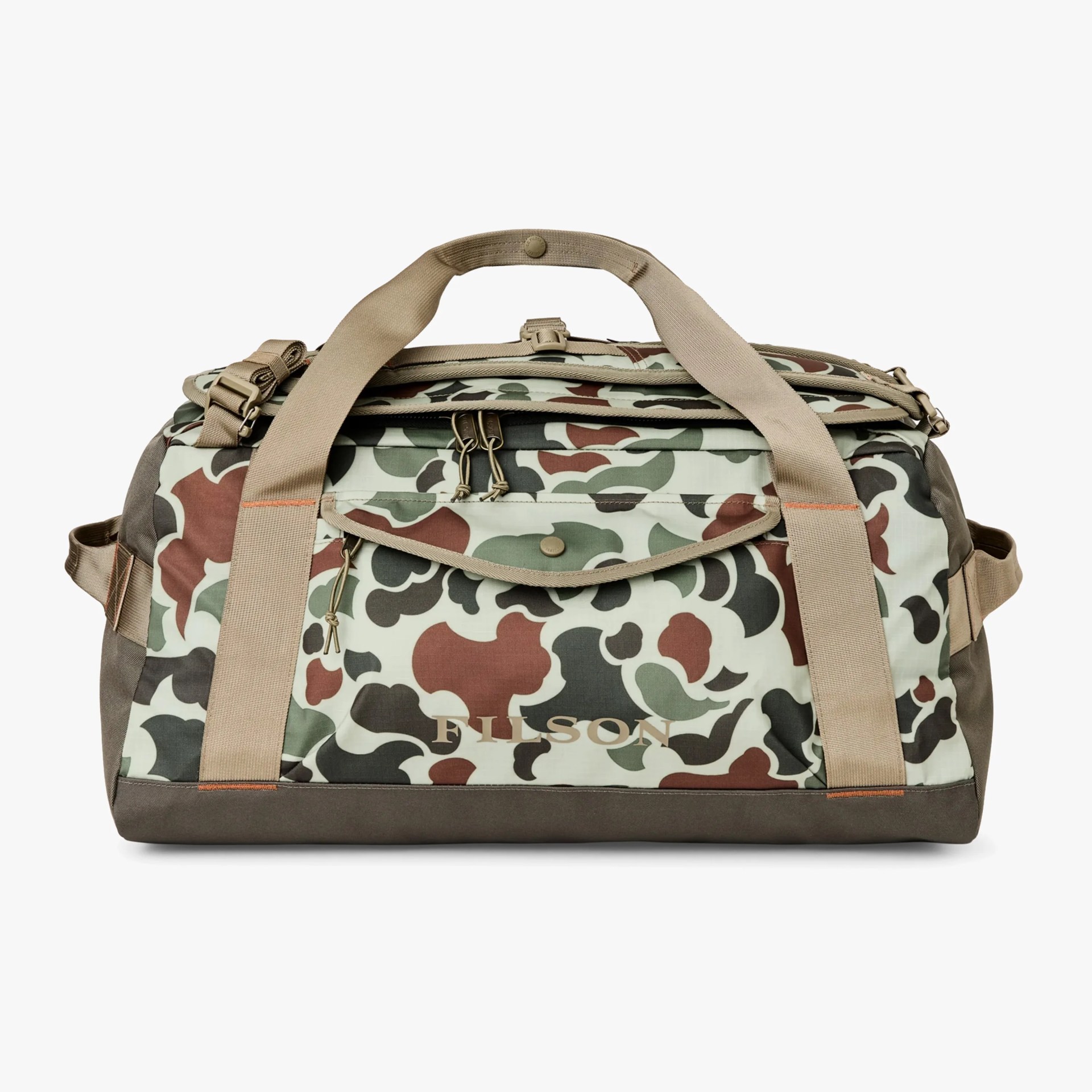 A duffel bag with a camouflage pattern in shades of green, brown, and black on a light background. It has beige handles and straps, a front zippered pocket with a flap secured by a snap button, and the brand name "FILSON" printed on the front pocket. The bag features multiple zippers and sturdy construction.