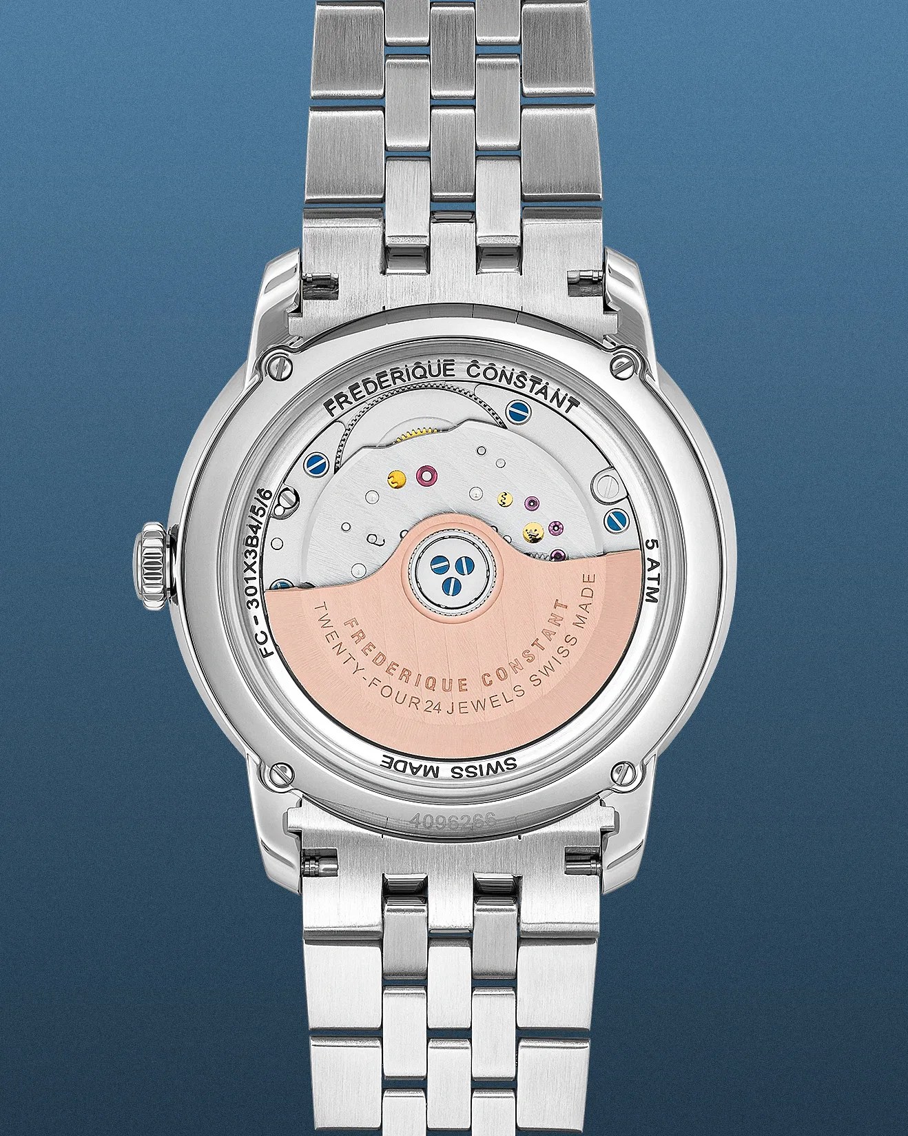 Back view of a Frederique Constant wristwatch showcasing its automatic movement mechanism. The watch features a stainless steel case and bracelet with a transparent case back revealing the rotor engraved with "FREDERIQUE CONSTANT TWENTY-FOUR 24 JEWELS SWISS MADE." The case back also displays the brand name, model number FC-301X3B4/5/6, and water resistance rating of 5 ATM. The movement includes visible screws and jewels, highlighting the craftsmanship of the Swiss-made watch.