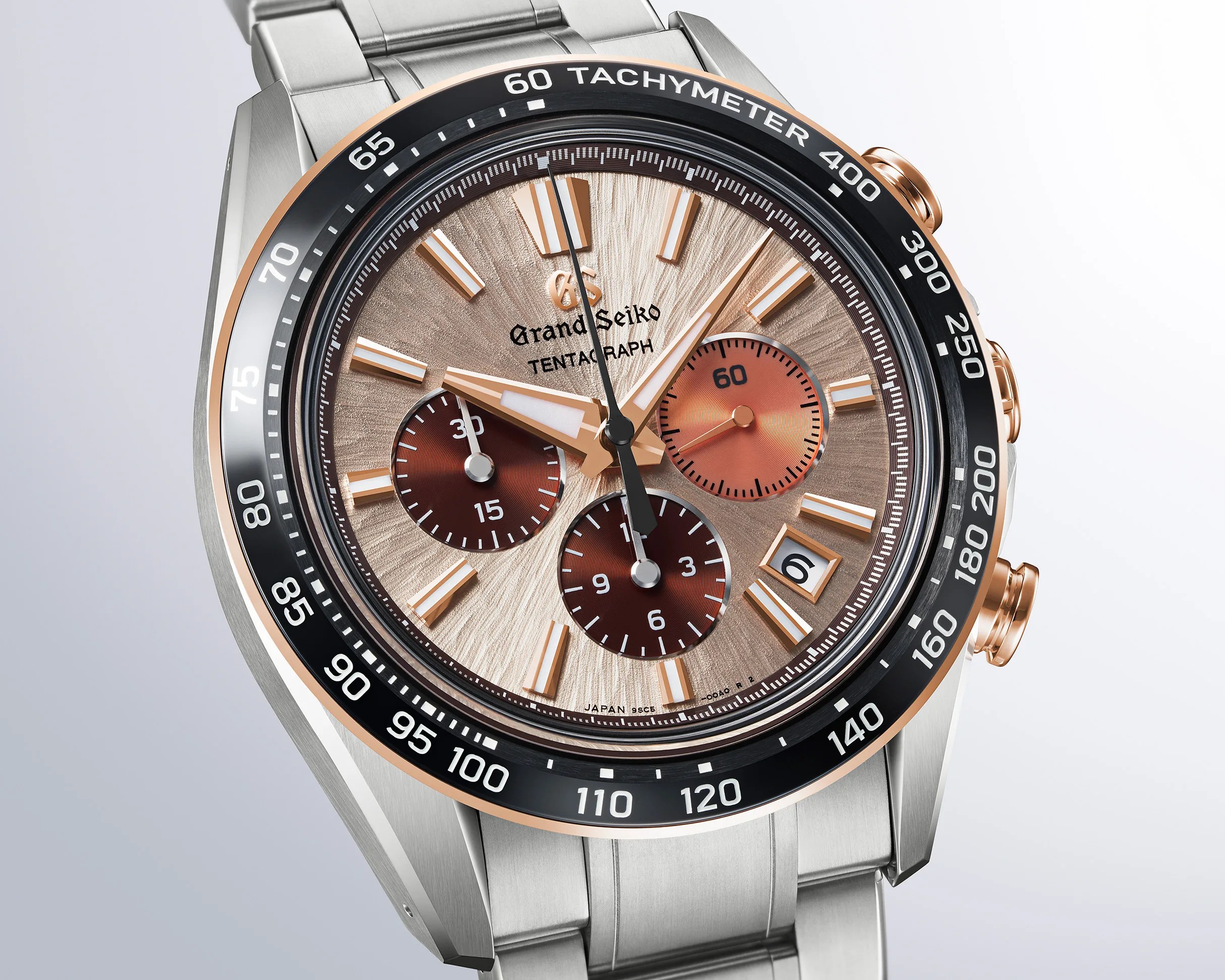 Grand Seiko Tentagraph watch with a textured champagne dial featuring rose gold-tone hour markers and hands. It has three subdials in shades of brown and copper, a date window at 4 o'clock, and a black tachymeter bezel with white markings. The watch case and bracelet are stainless steel with rose gold-tone accents on the bezel edge and pushers.