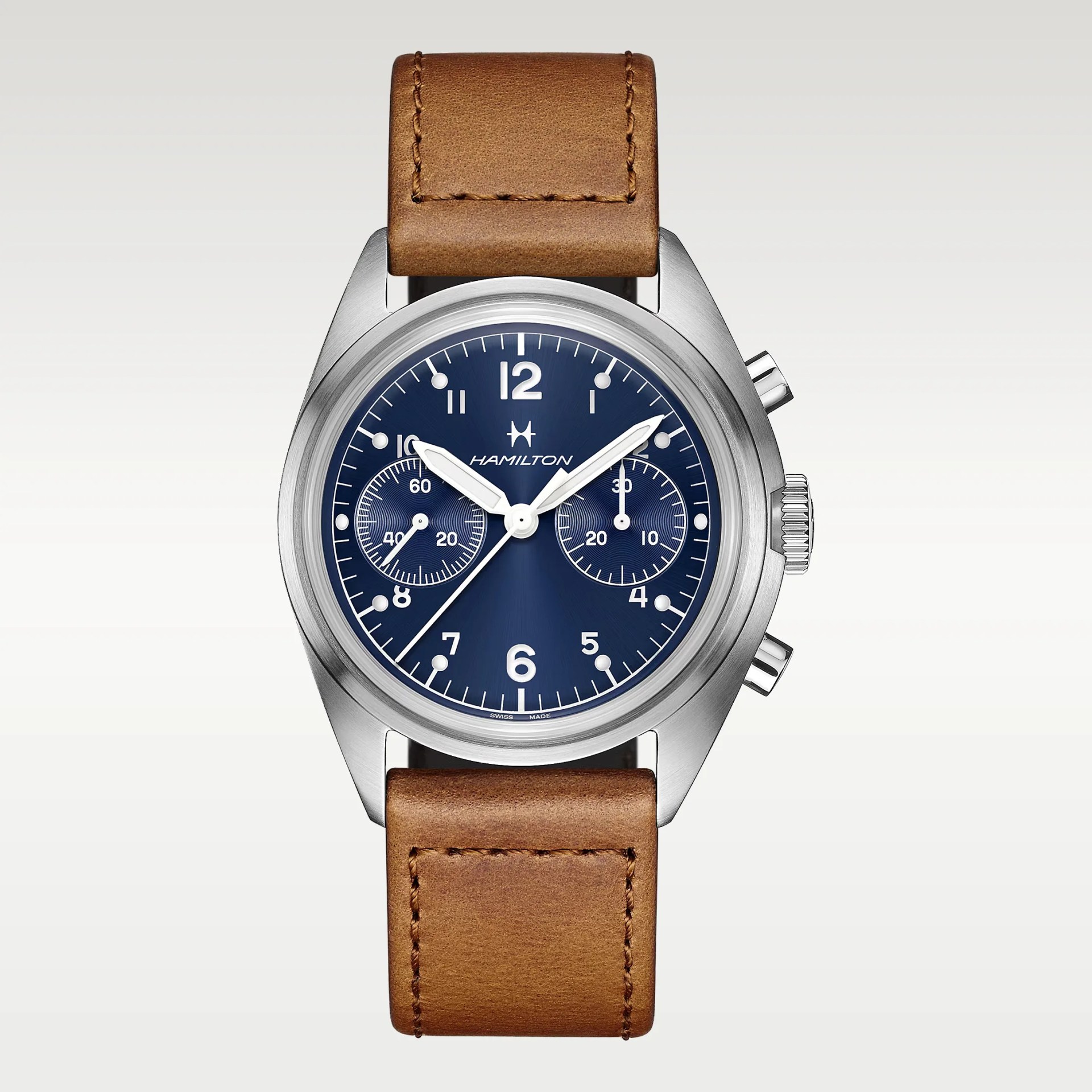 Hamilton wristwatch with a round stainless steel case, a deep blue dial featuring white Arabic numerals and markers, two subdials, and white hands. The watch has a brown leather strap with visible stitching and two push buttons on the right side of the case.