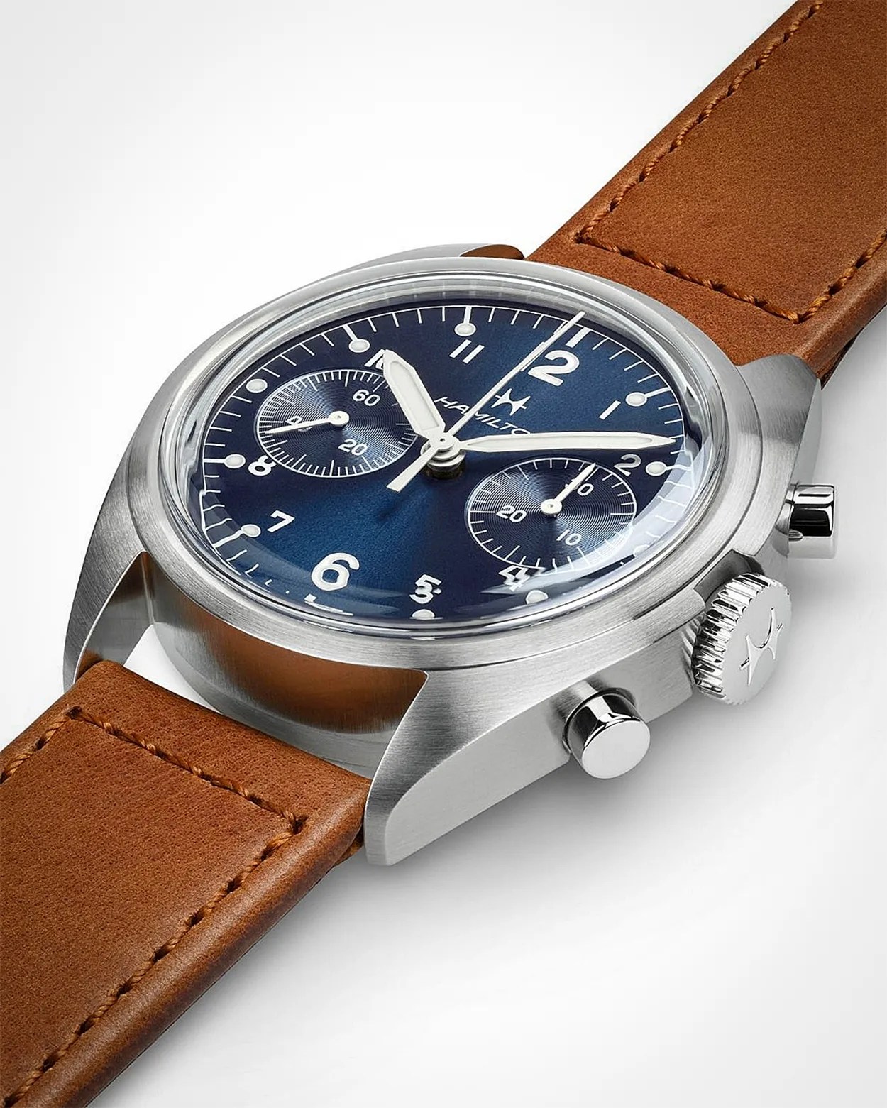 Stainless steel wristwatch with a deep blue dial featuring white Arabic numerals and two subdials. The watch has silver-tone hands and a brown leather strap with visible stitching. The crown and two pushers are located on the right side of the case. The brand name "Hamilton" is visible on the dial.