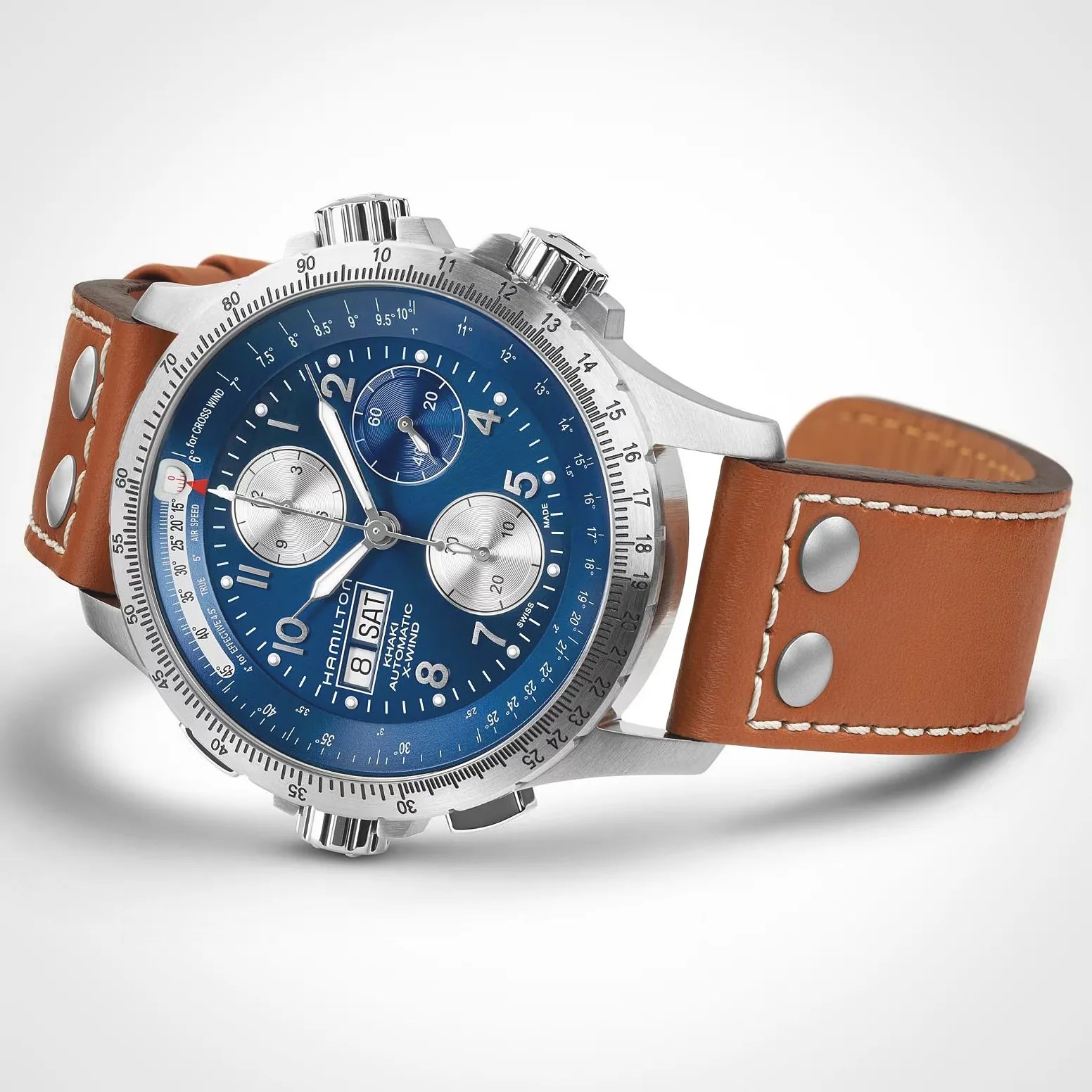 Silver stainless steel Hamilton Khaki automatic wristwatch with a blue dial featuring three subdials, white numerals, and a day-date window at 9 o'clock. The watch has a rotating bezel with detailed markings and a brown leather strap with white stitching and two metal rivets near the lugs.