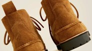 Pair of brown suede boots with visible stitching, leather pull tabs at the back, and black rubber lug soles.