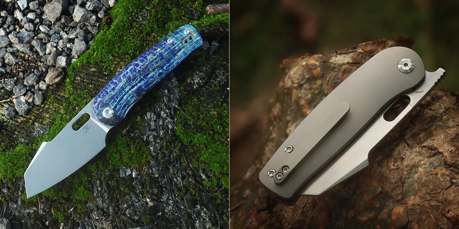 A folding knife with a blue textured handle and a wide, angular blade resting on moss and gravel. Next to it, a closed folding knife with a smooth, matte gray handle and a clip, placed on rough tree bark.