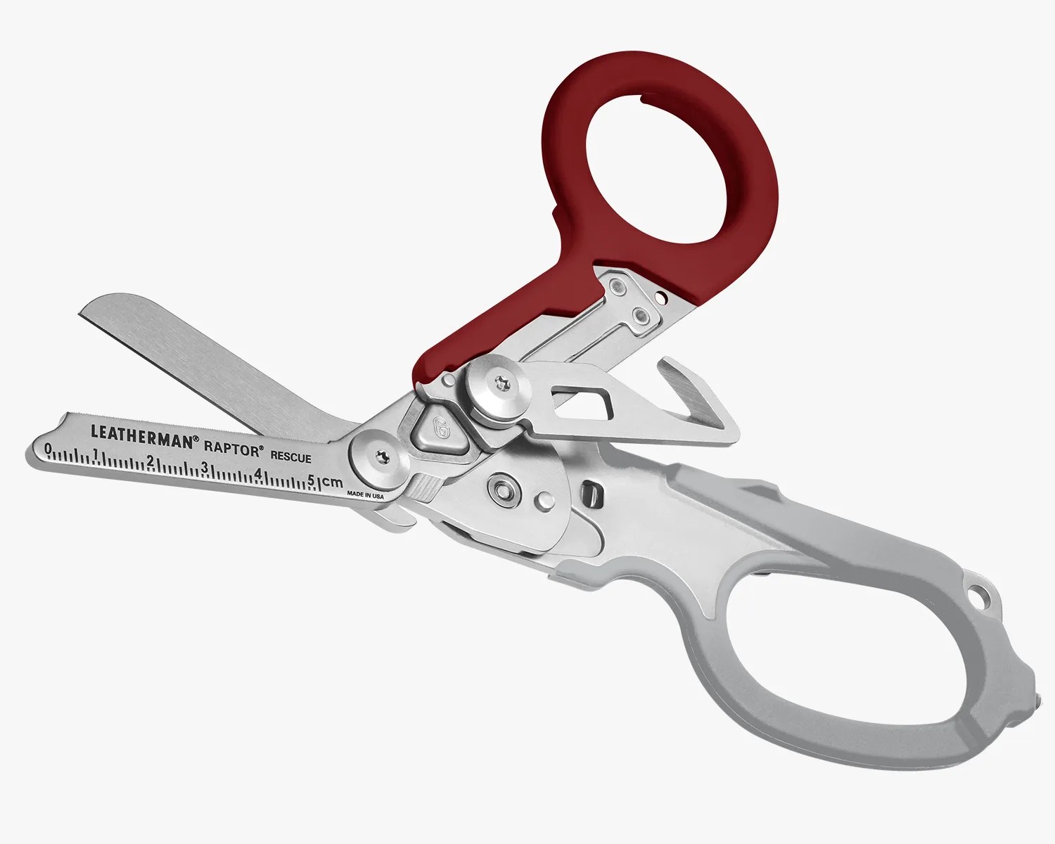 Leatherman Raptor Rescue shears with stainless steel blades and red and gray ergonomic handles, featuring a built-in ruler and multiple rescue tools.
