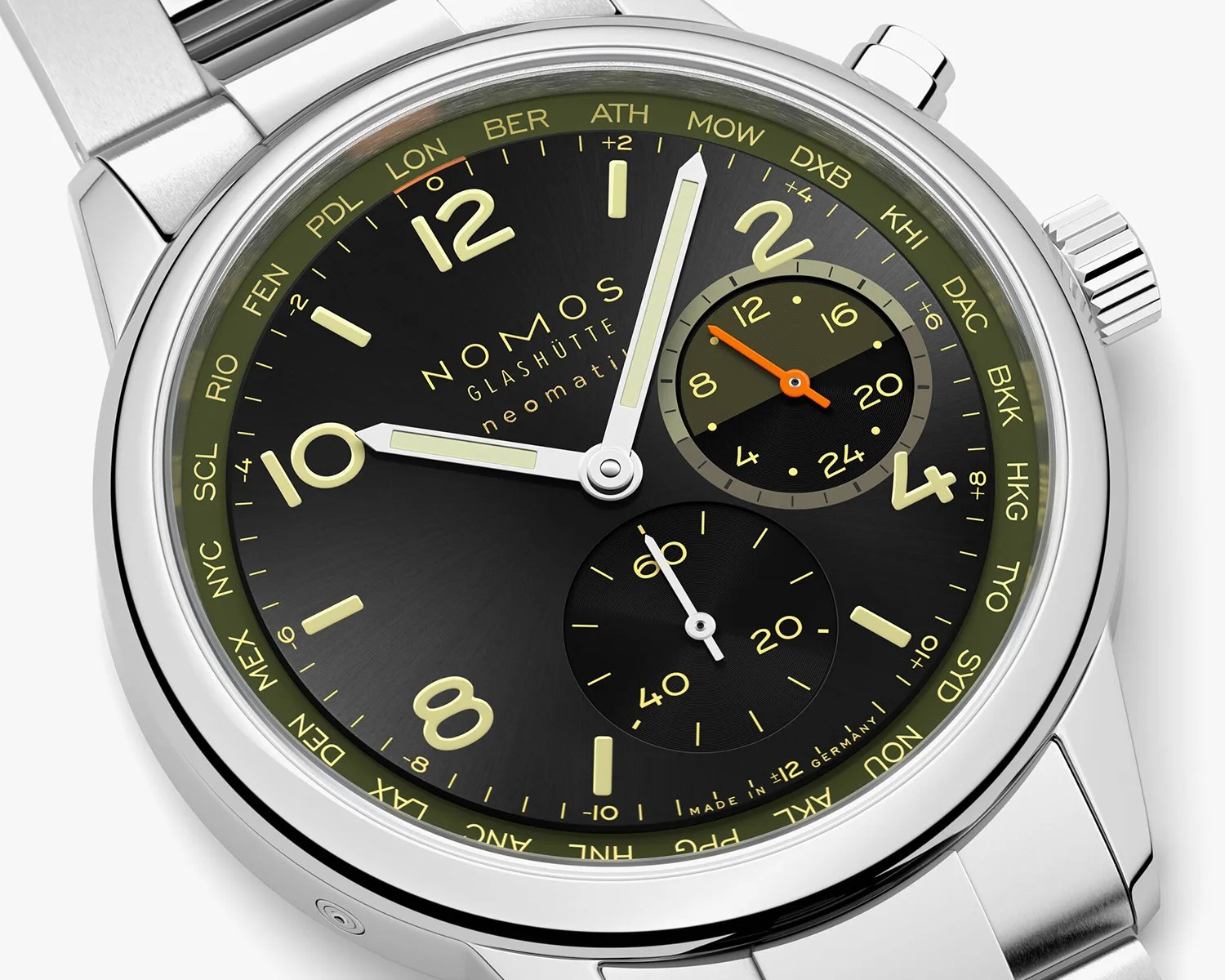 Close-up of a Nomos Glashütte neomatik wristwatch with a black dial, luminous yellowish hour markers and hands, and a stainless steel case and bracelet. The watch features a 24-hour subdial at the 2 o'clock position with an orange hand, a seconds subdial at the 6 o'clock position, and a world time ring around the outer edge displaying city abbreviations in yellow. The main hands show the time as approximately 10:08.