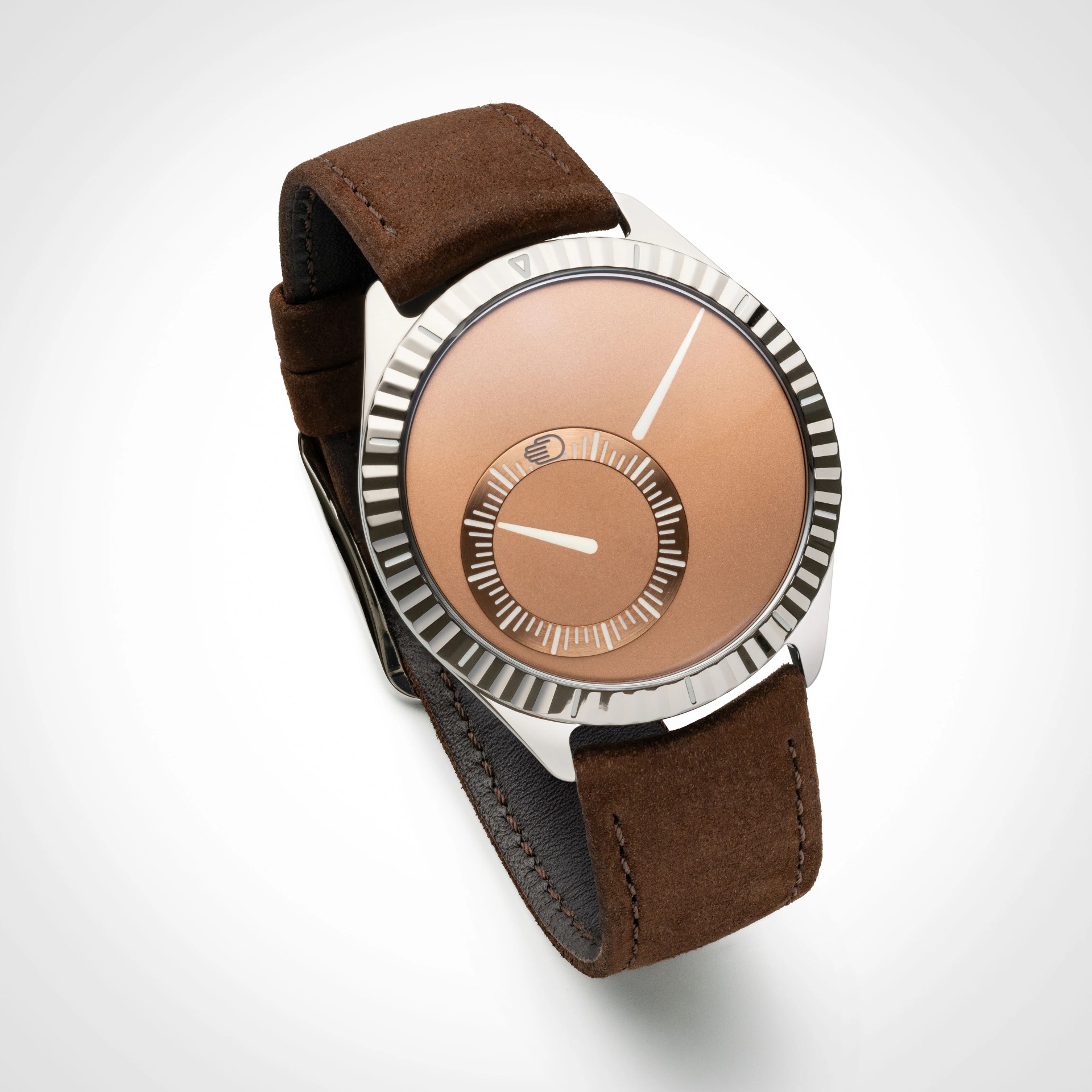 Watch with a polished silver bezel and a smooth, copper-colored dial featuring two white hands. The dial includes a smaller circular sub-dial with white markings and a hand icon. The strap is made of brown suede leather with visible stitching.