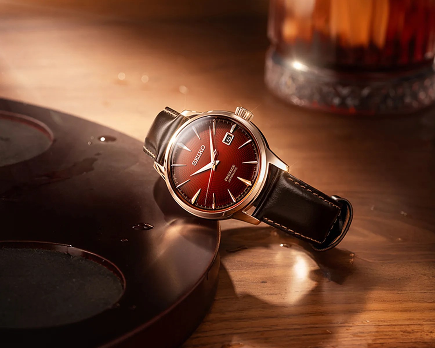 a Seiko watch with a red dial