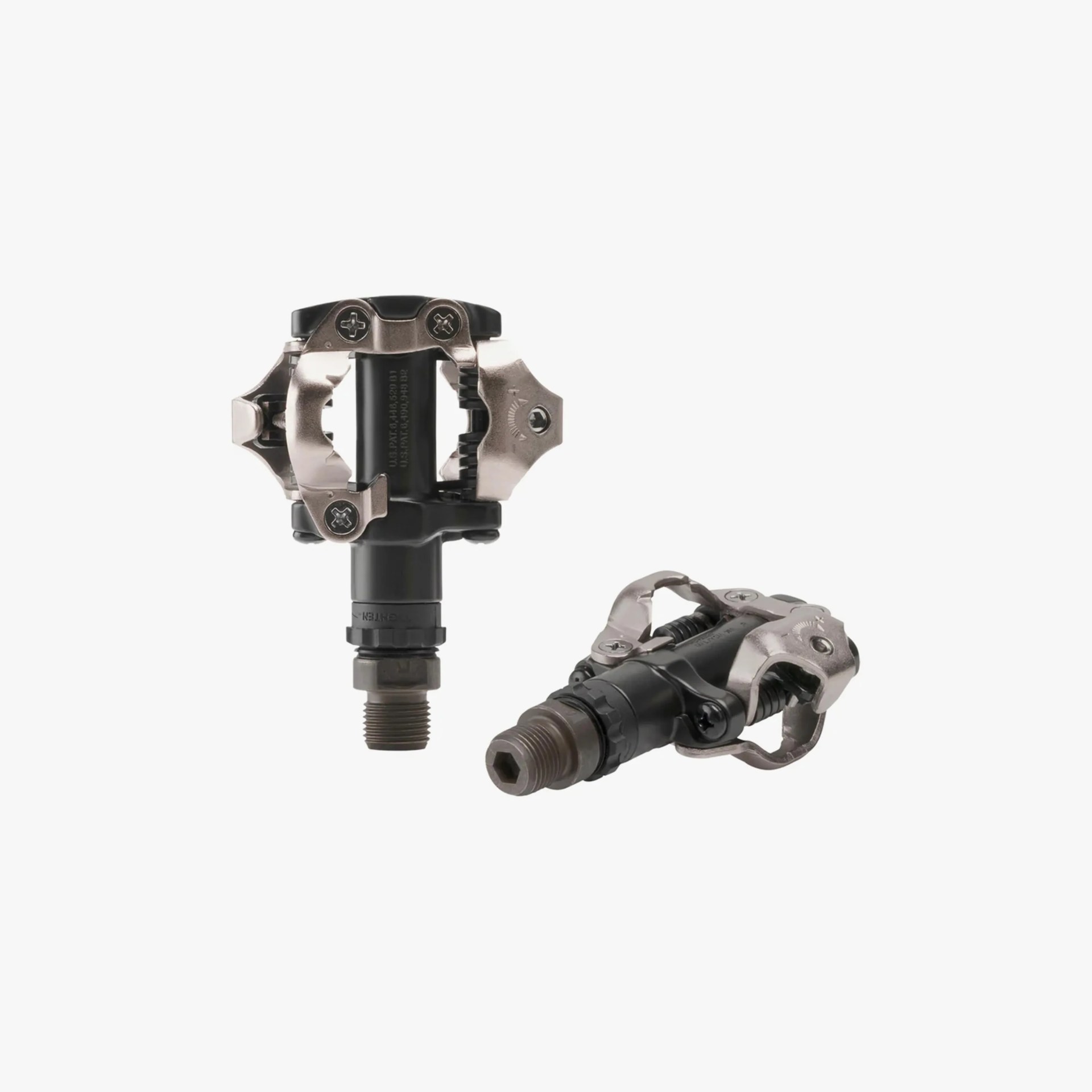Pair of black and silver clipless bicycle pedals with metal cleat retention mechanisms and threaded spindles.