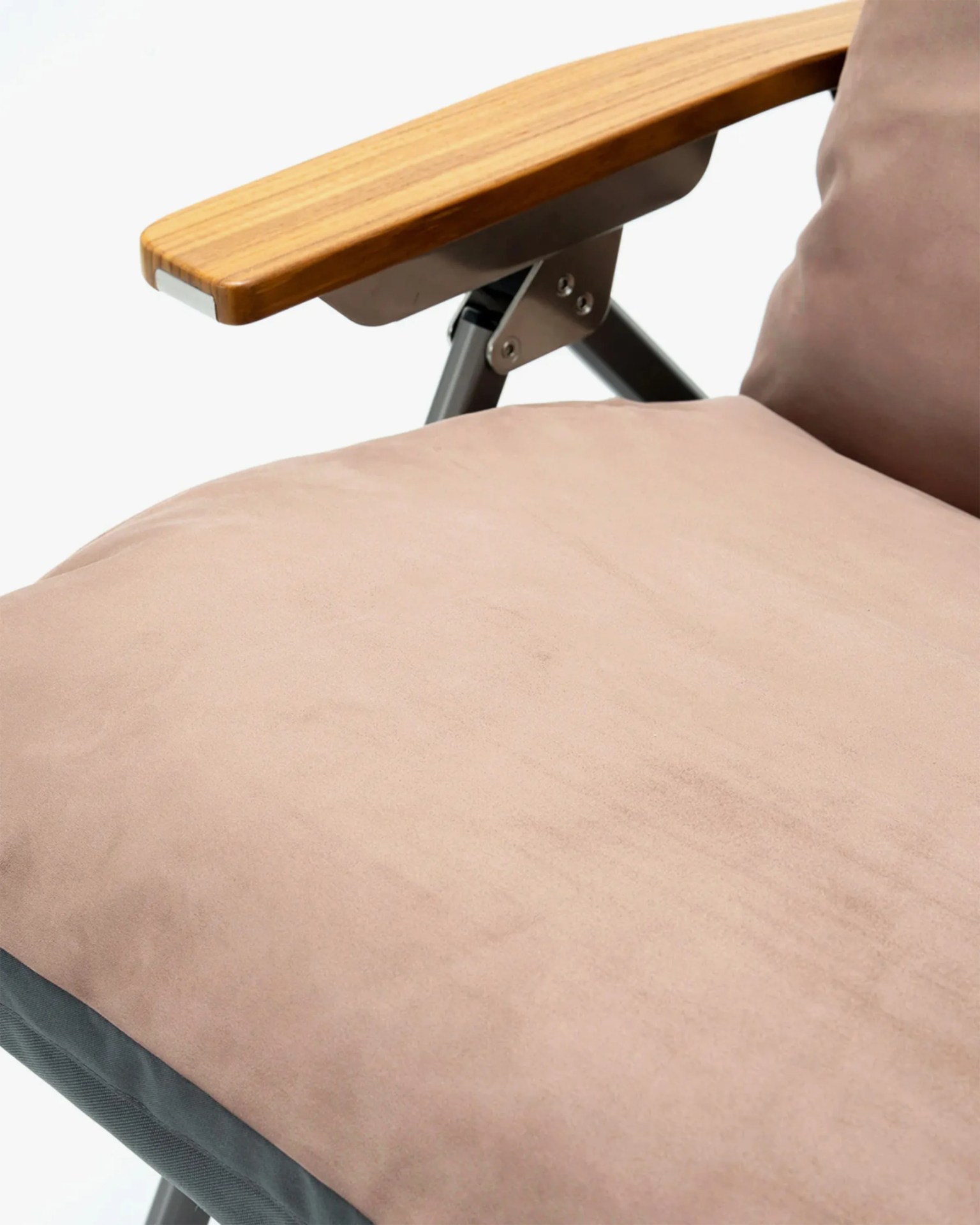 Close-up of a chair featuring a light brown cushioned seat and backrest with a soft fabric texture, a wooden armrest with a smooth finish, and metal support brackets.