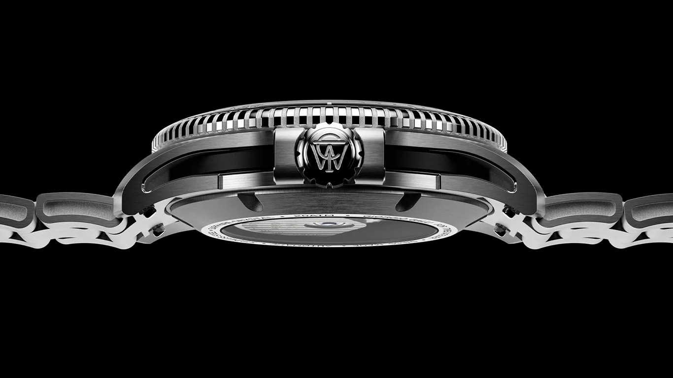Side view of a stainless steel Timex wristwatch showing the crown with an engraved logo, a textured bezel, and a metal link bracelet against a black background.