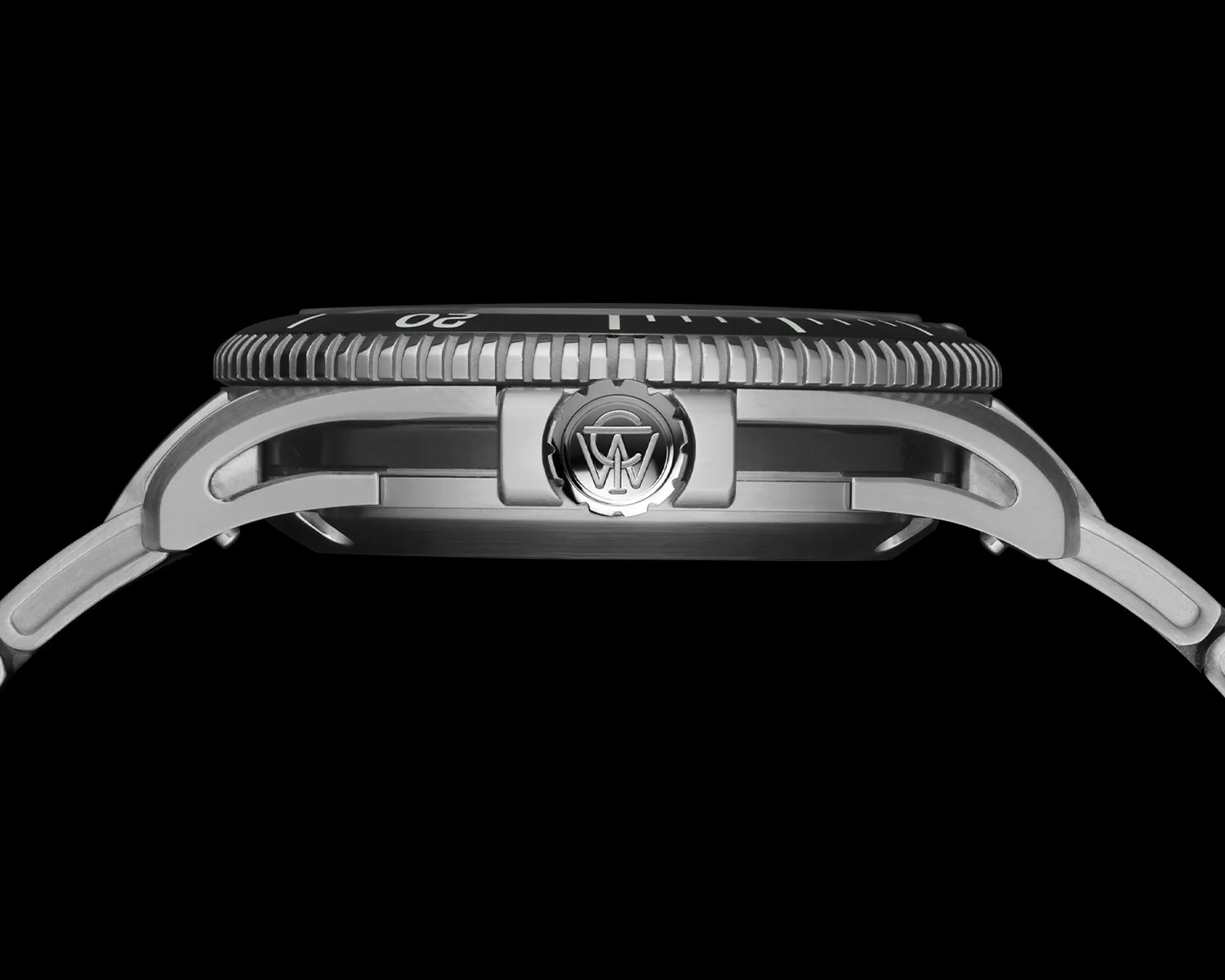 Side view of a silver wristwatch with a ridged bezel and a crown featuring an engraved logo. The watch has an open lug design and a metal bracelet. The background is black.
