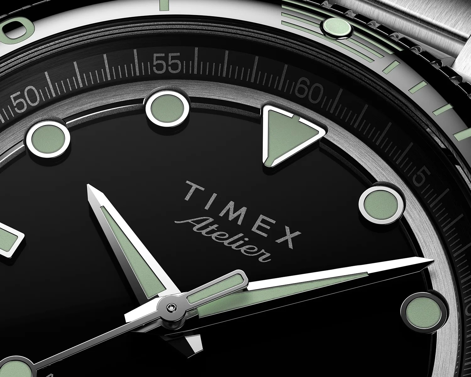Close-up of a Timex Atelier watch face featuring a black dial with luminous green hour markers and hands. The hour markers include circular and triangular shapes, and the bezel has minute markings with luminous accents. The watch hands are silver with green luminous insets. The brand name "TIMEX Atelier" is printed in the center of the dial. The watch case is metallic with a brushed finish.