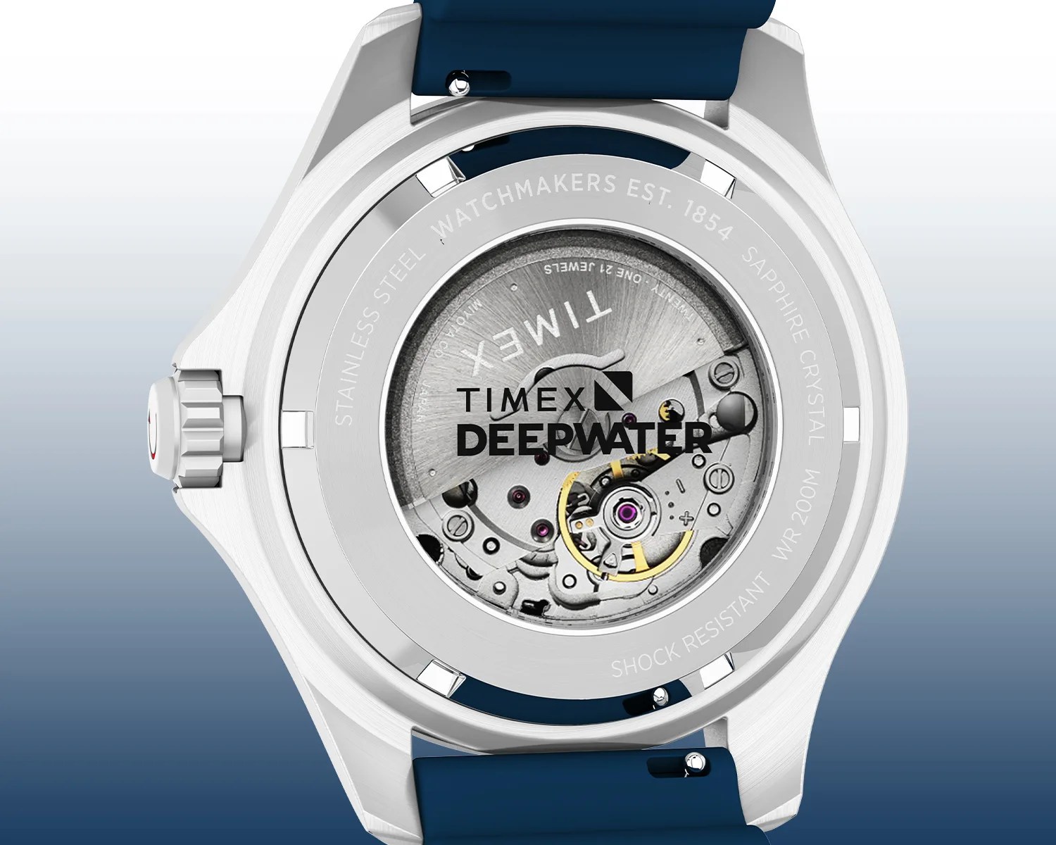 Back view of a Timex Deepwater watch showcasing its stainless steel case and visible mechanical movement through a crystal case back. The watch features a blue strap and is engraved with details including "STAINLESS STEEL," "WATCHMAKERS EST. 1854," "SAPPHIRE CRYSTAL," "SHOCK RESISTANT," and "WR 200M.