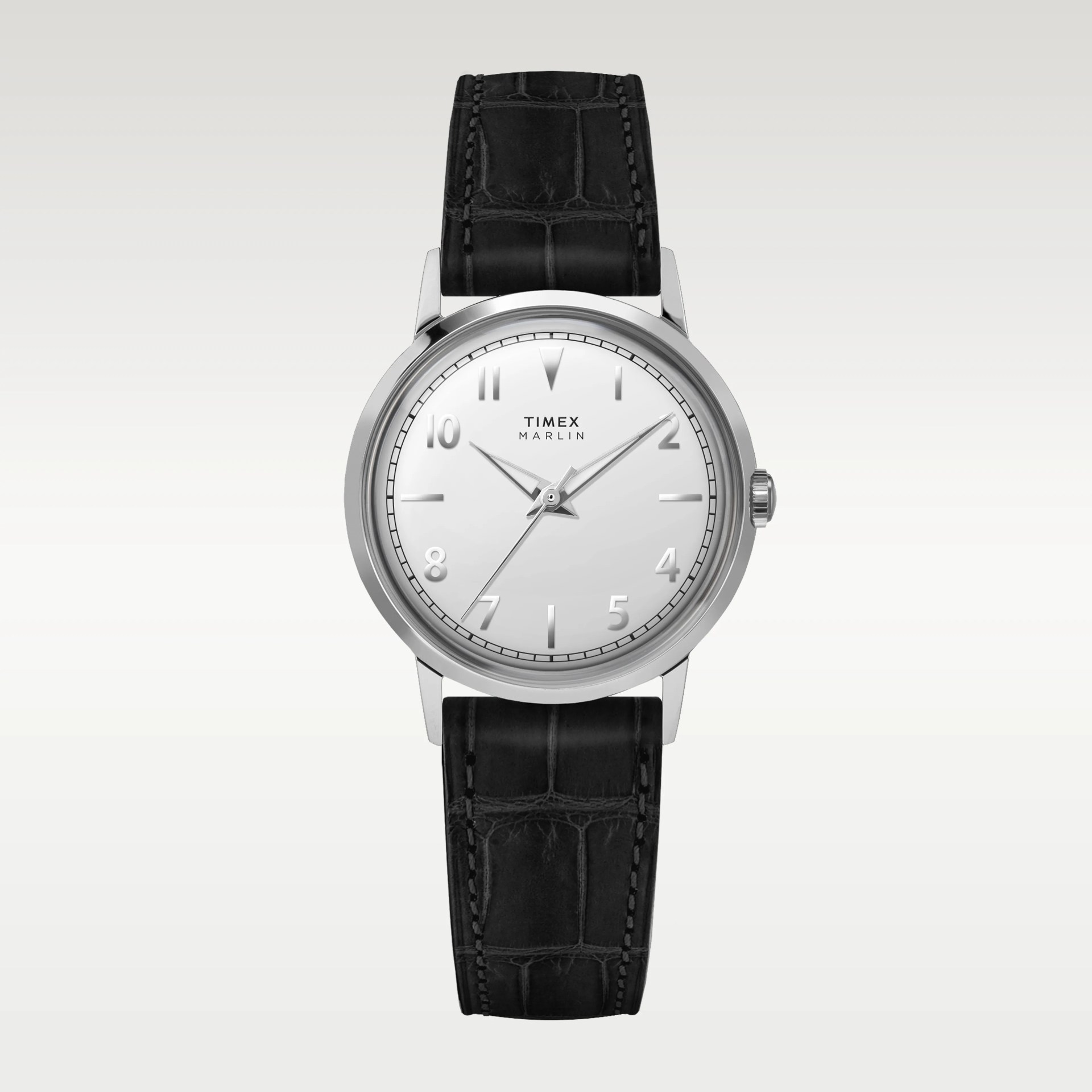 Timex Marlin wristwatch with a polished silver round case, white dial, and silver hour markers and hands. The watch features a black leather strap with a crocodile pattern and visible stitching. The dial includes the Timex Marlin logo below the 12 o'clock position.