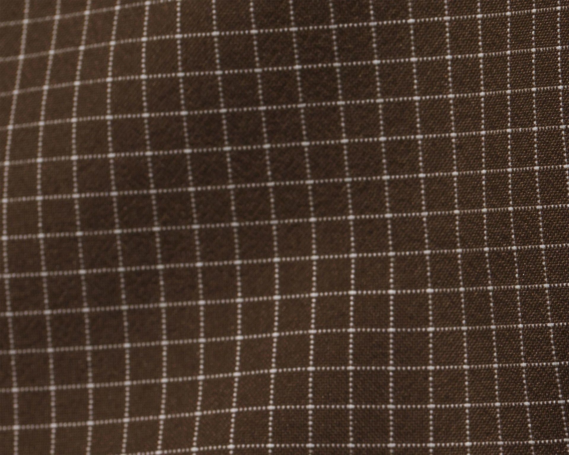 Brown fabric with a white grid pattern consisting of evenly spaced horizontal and vertical lines forming small squares. The texture of the fabric is visible, showing a woven material.