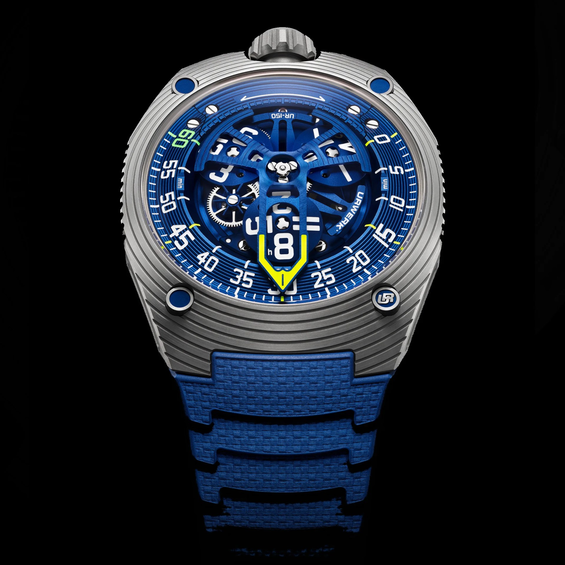 A futuristic wristwatch with a metallic silver case featuring horizontal grooves and blue accents on the screws. The dial is predominantly blue with a complex, open-worked design showing mechanical gears. White numerals and minute markers encircle the dial, with a prominent yellow and blue arrow-shaped indicator pointing to the current time. The watch strap is textured blue, complementing the dial's color scheme. The brand name "URWERK" is visible on the dial.