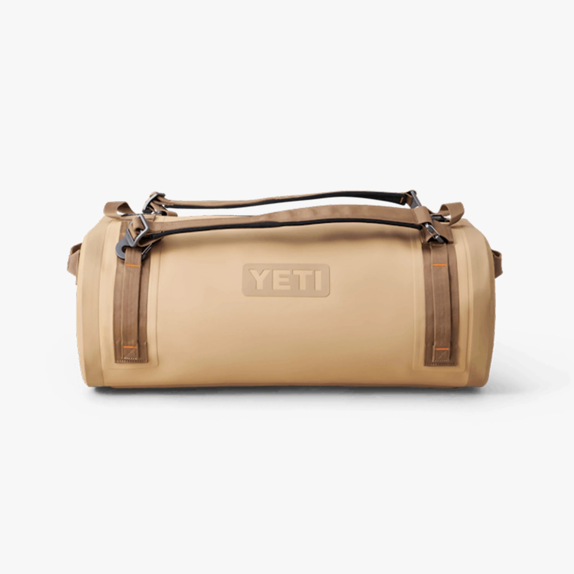 Tan cylindrical YETI duffel bag with brown adjustable shoulder straps and the YETI logo embossed on the side.