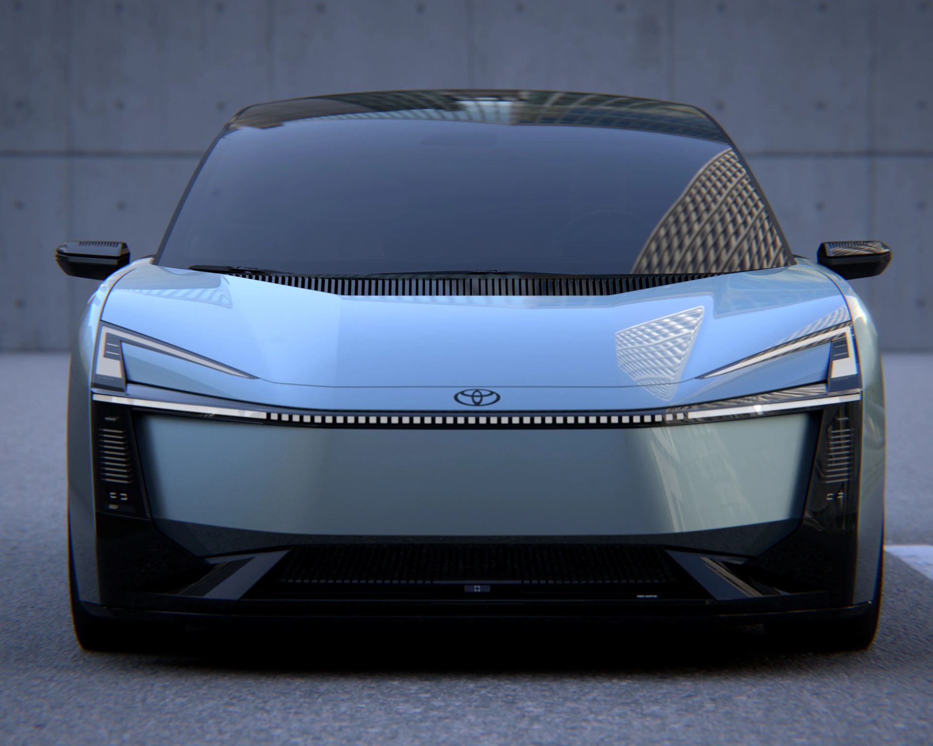 Front view of a sleek silver Toyota electric car with a black roof and futuristic LED headlights.