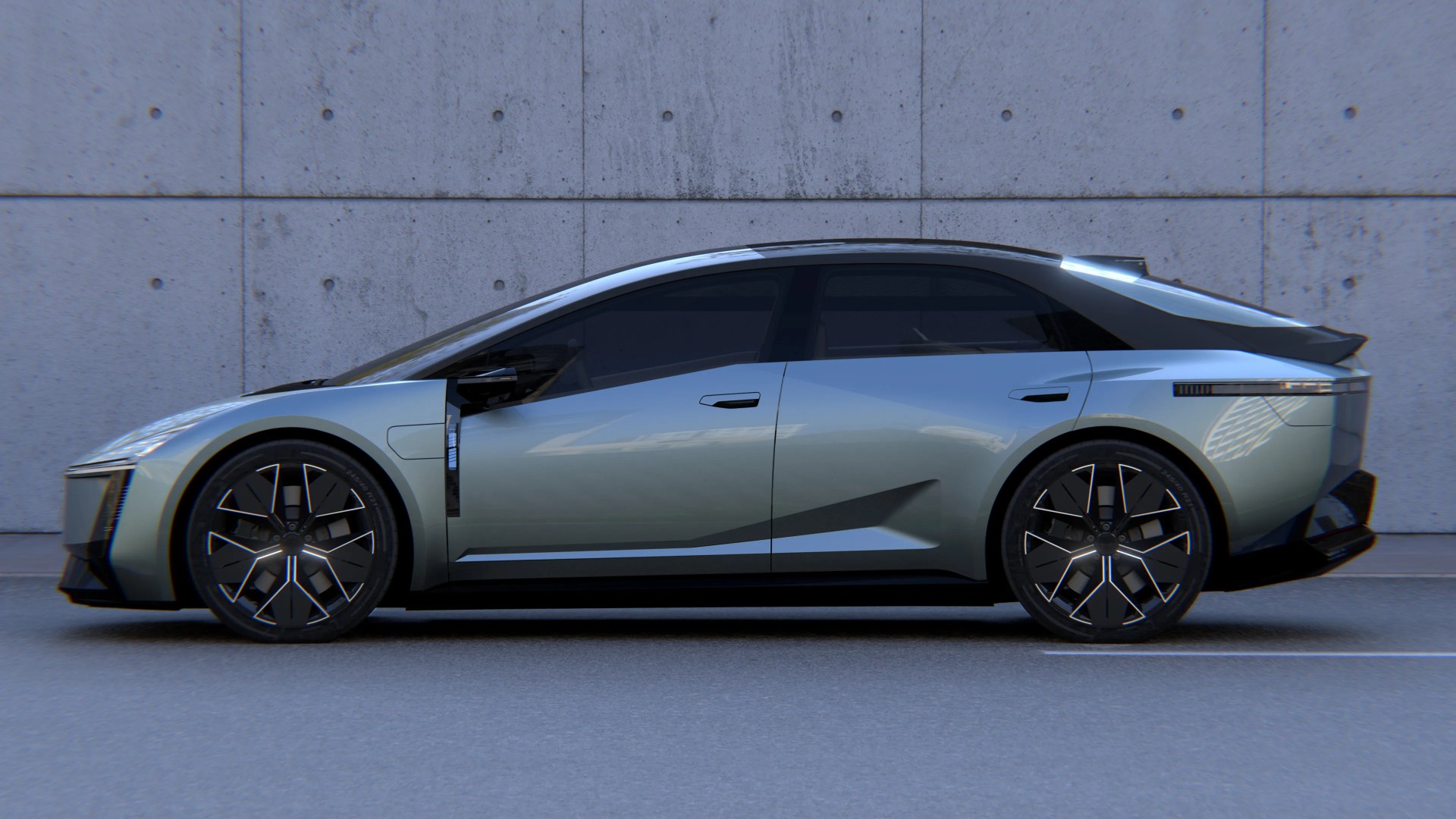 Sleek silver electric sedan with black roof and modern alloy wheels parked by a concrete wall.