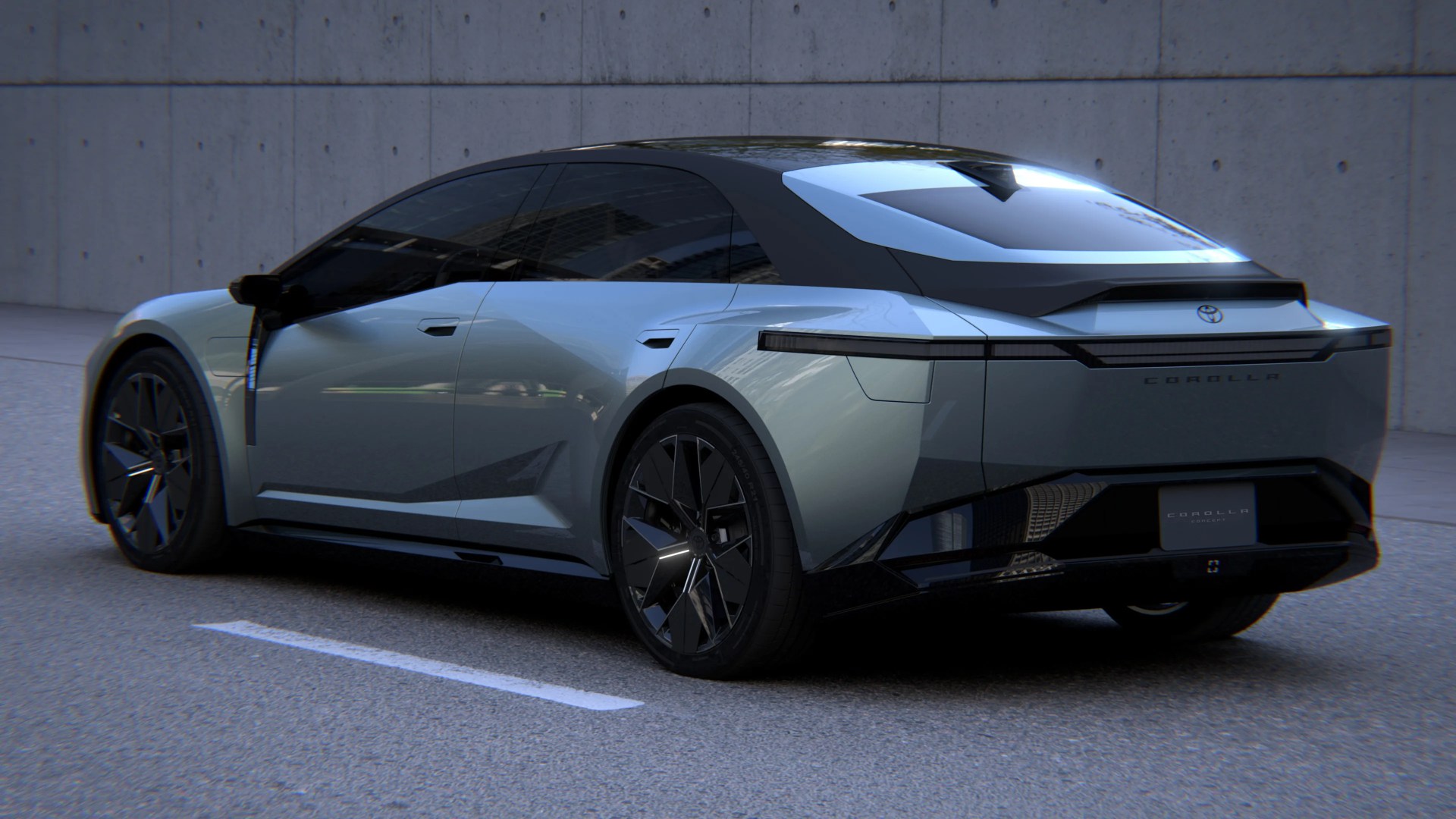 Sleek silver Toyota Corolla concept car with black roof and tinted windows parked on asphalt.