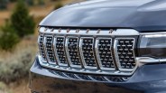 Close-up of a black Jeep Wagoneer front grille with chrome accents and a front camera.