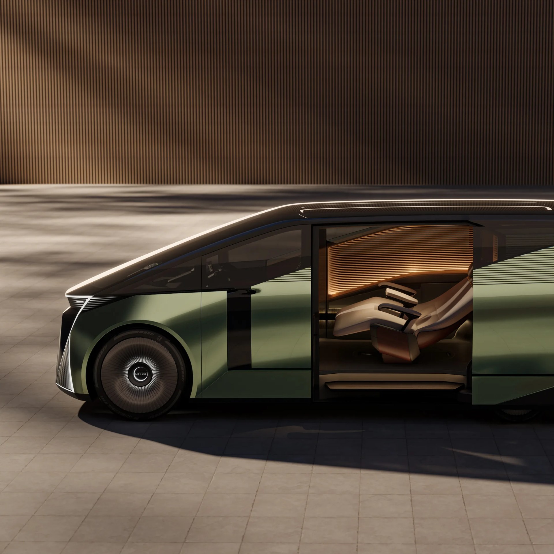Side view of a green Lexus electric vehicle with sliding door open, showing a futuristic reclining interior seat.