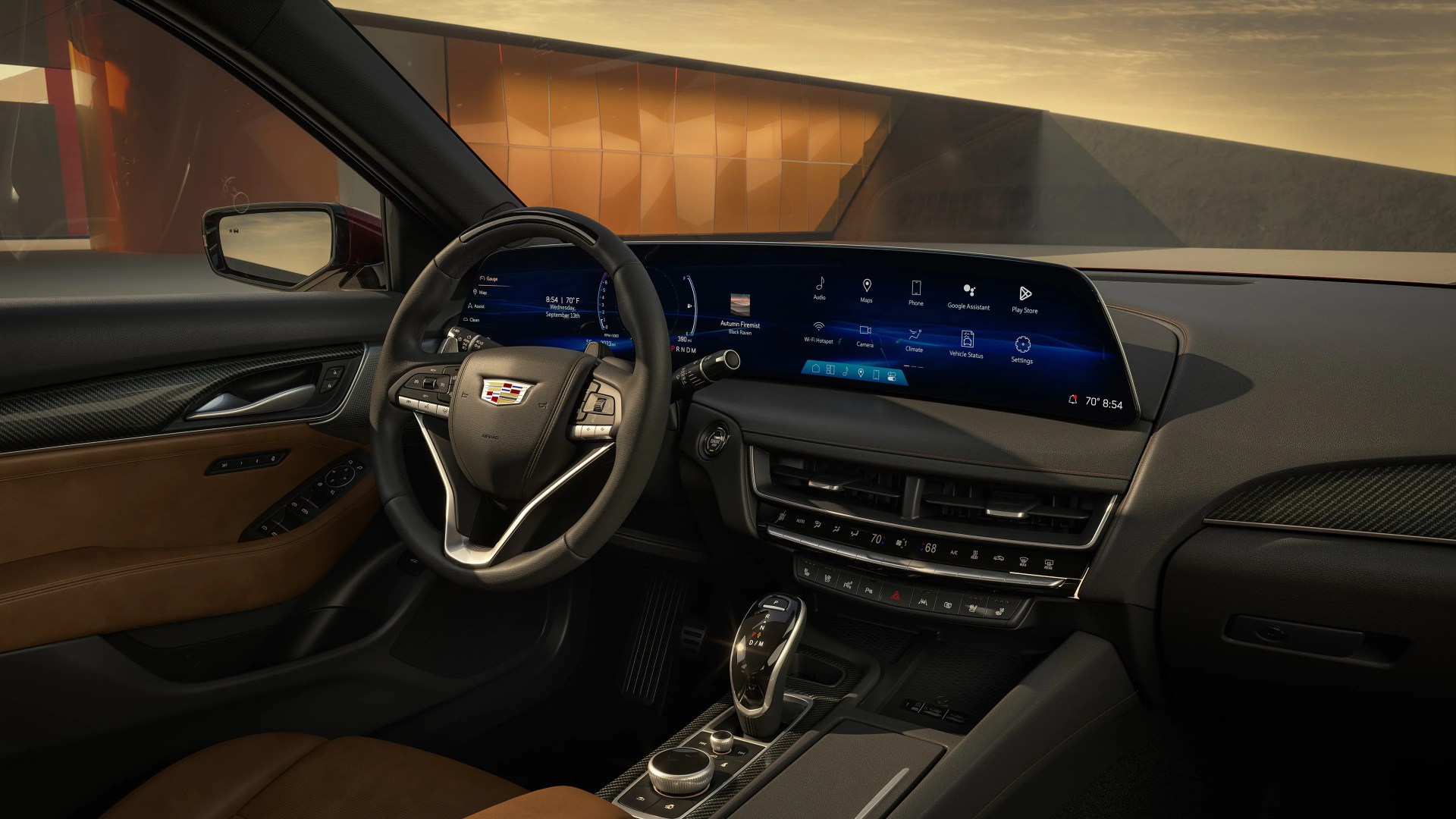 Luxury car interior with brown leather seats, black leather steering wheel featuring Cadillac logo, and wide digital dashboard display.