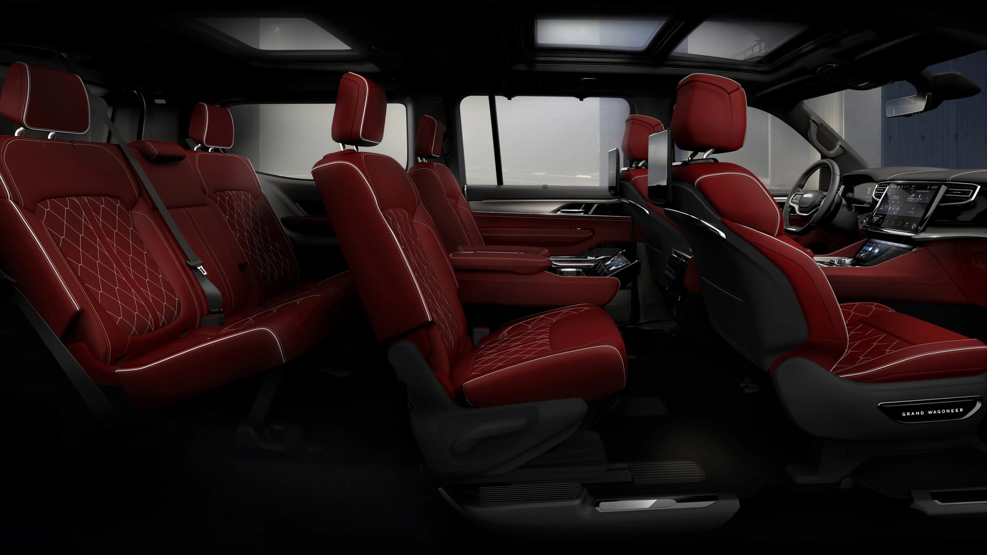 Interior of a vehicle with three rows of red leather seats featuring white stitching and diamond patterns.