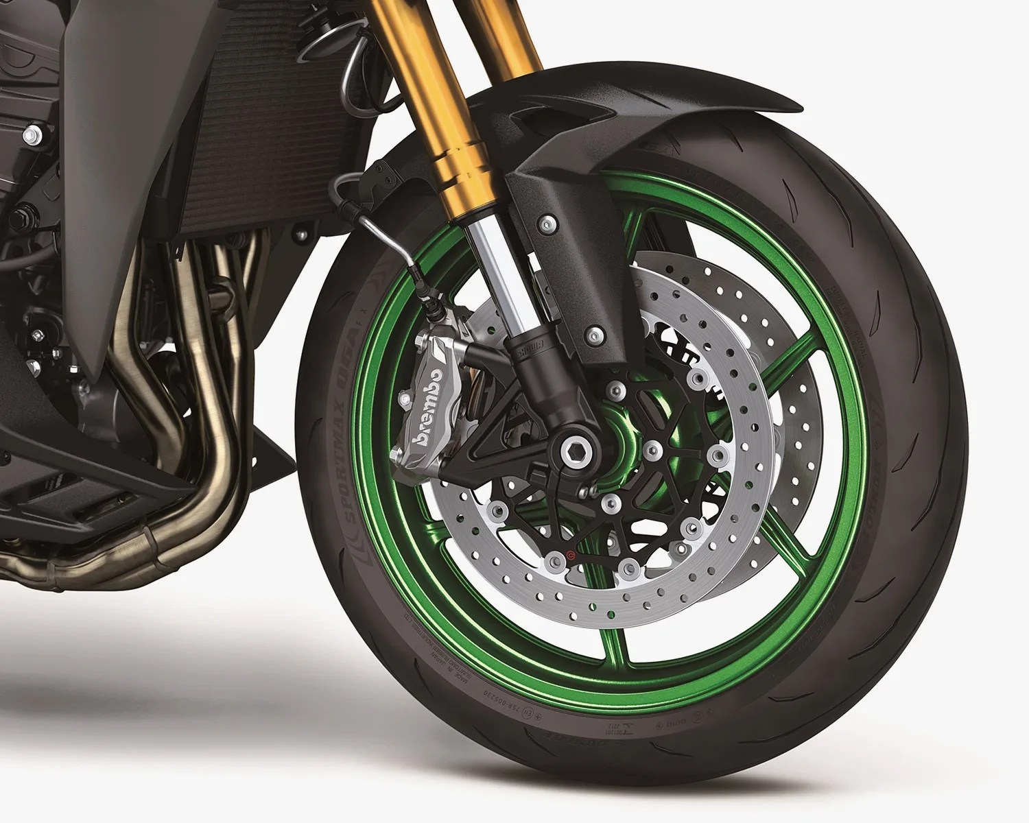 Front motorcycle wheel with green rim, dual disc brakes, Brembo caliper, and gold suspension forks.