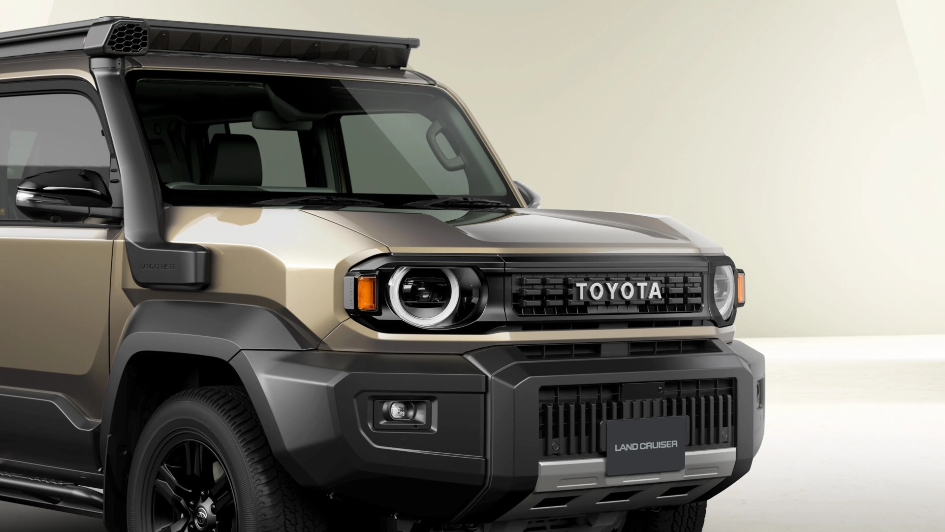 Front side view of a beige and black Toyota Land Cruiser with a roof rack and rugged design.