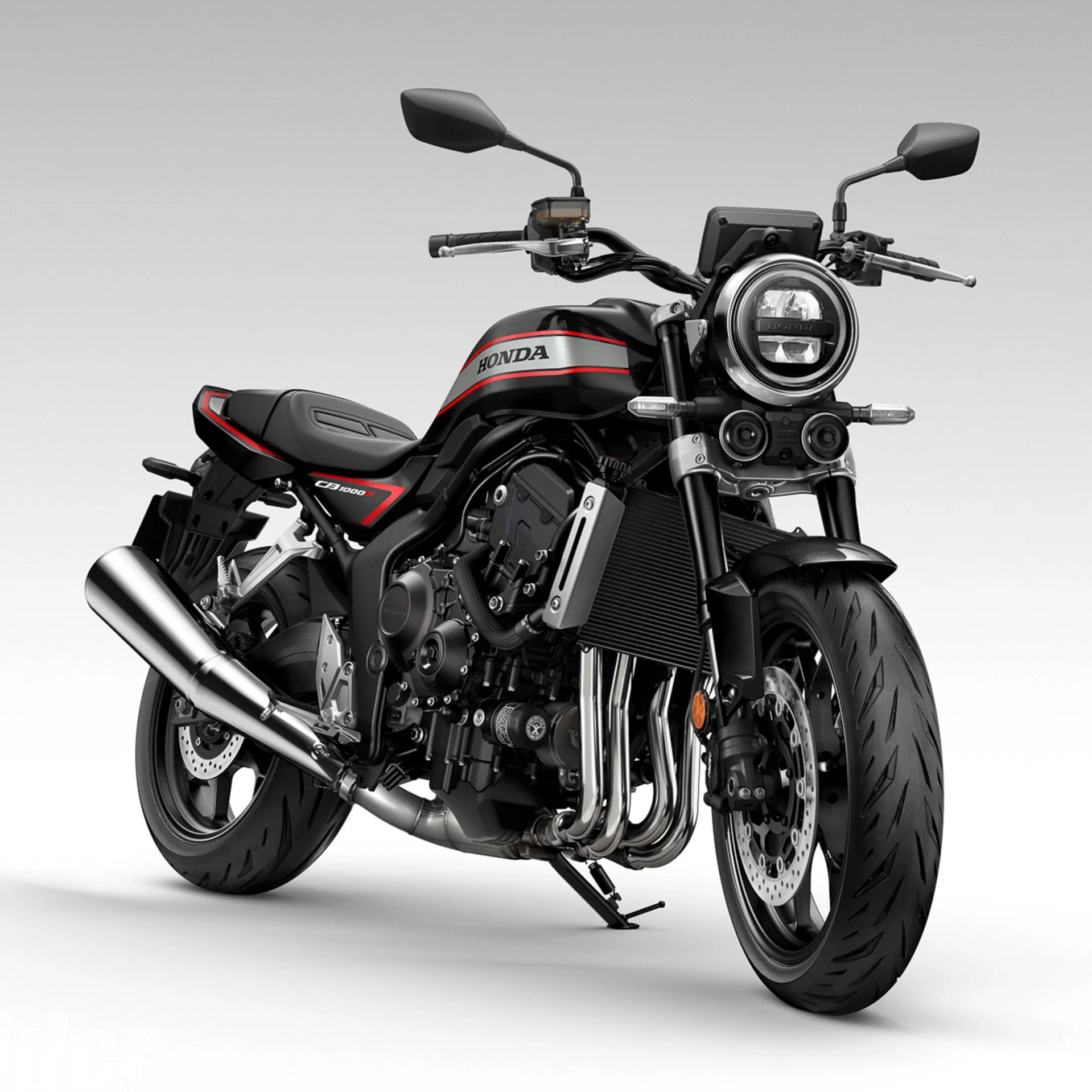 Black and red Honda CB1000R motorcycle with round headlight and chrome exhaust on a white background.