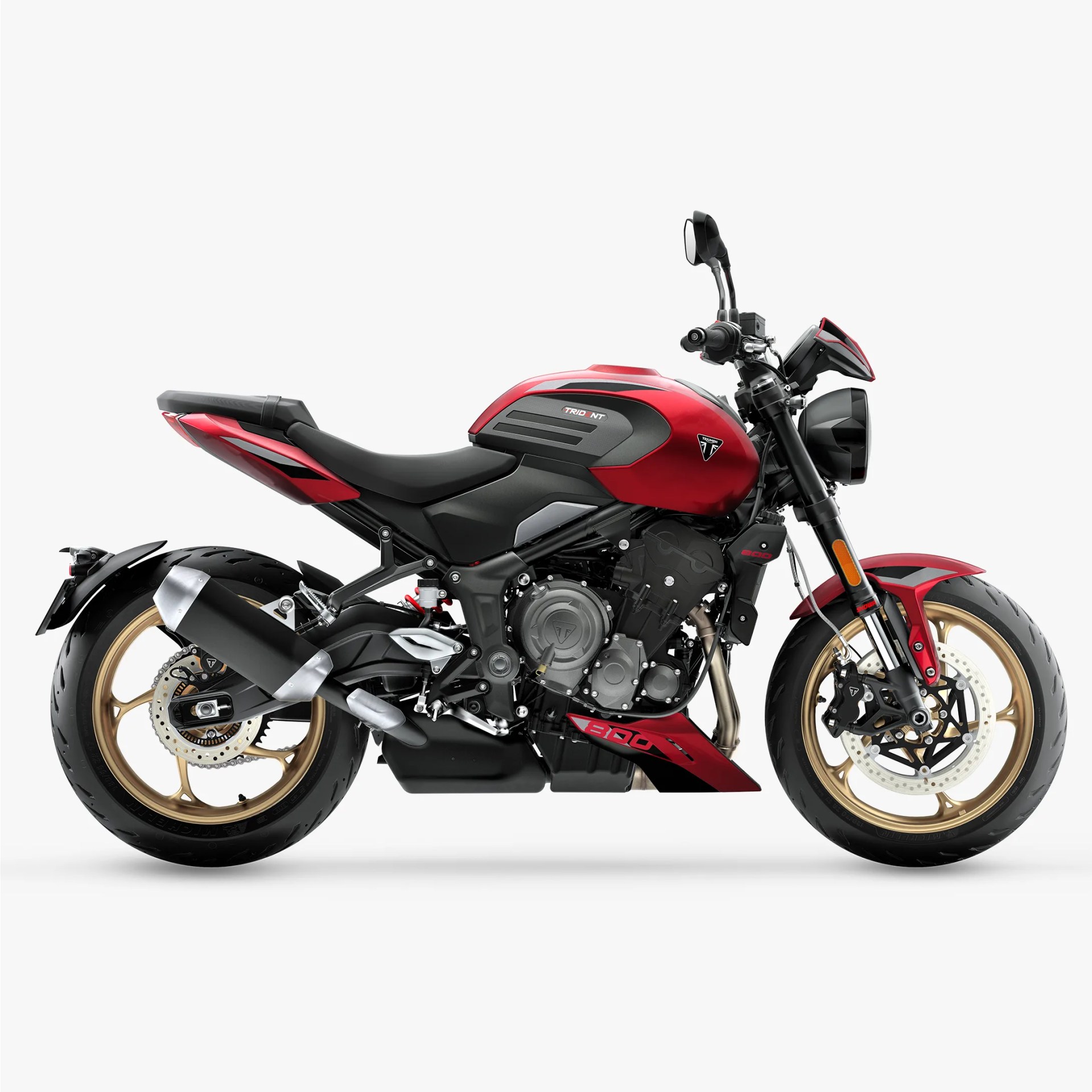 Red and black Triumph Trident 900 motorcycle with gold wheels on a white background.