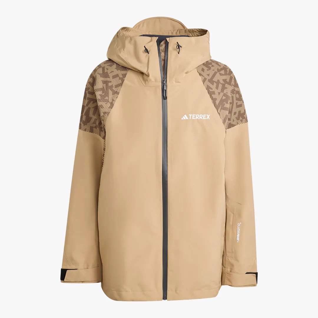 Beige hooded jacket with black patterned shoulder panels, front zipper, and TERREX logo on chest.
