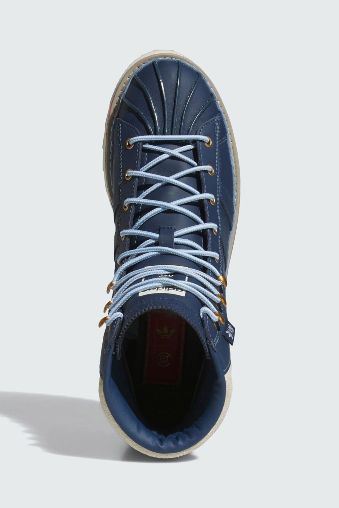 Navy blue high-top sneaker with light blue laces and beige sole viewed from above.
